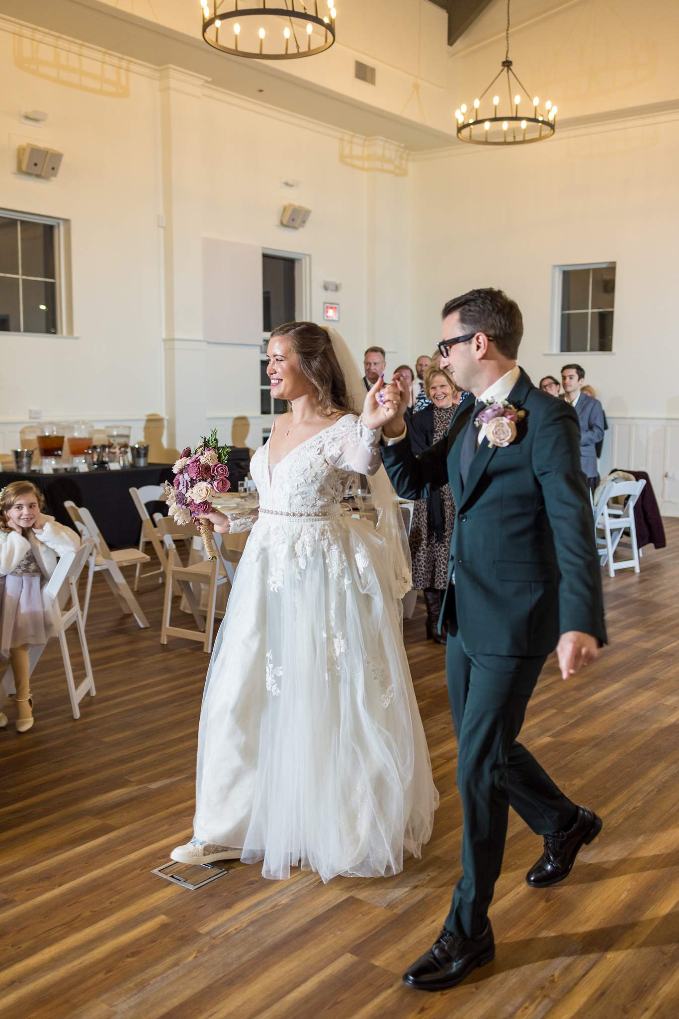 Couple walking into their reception at 240 Glynn Street in Fayetteville