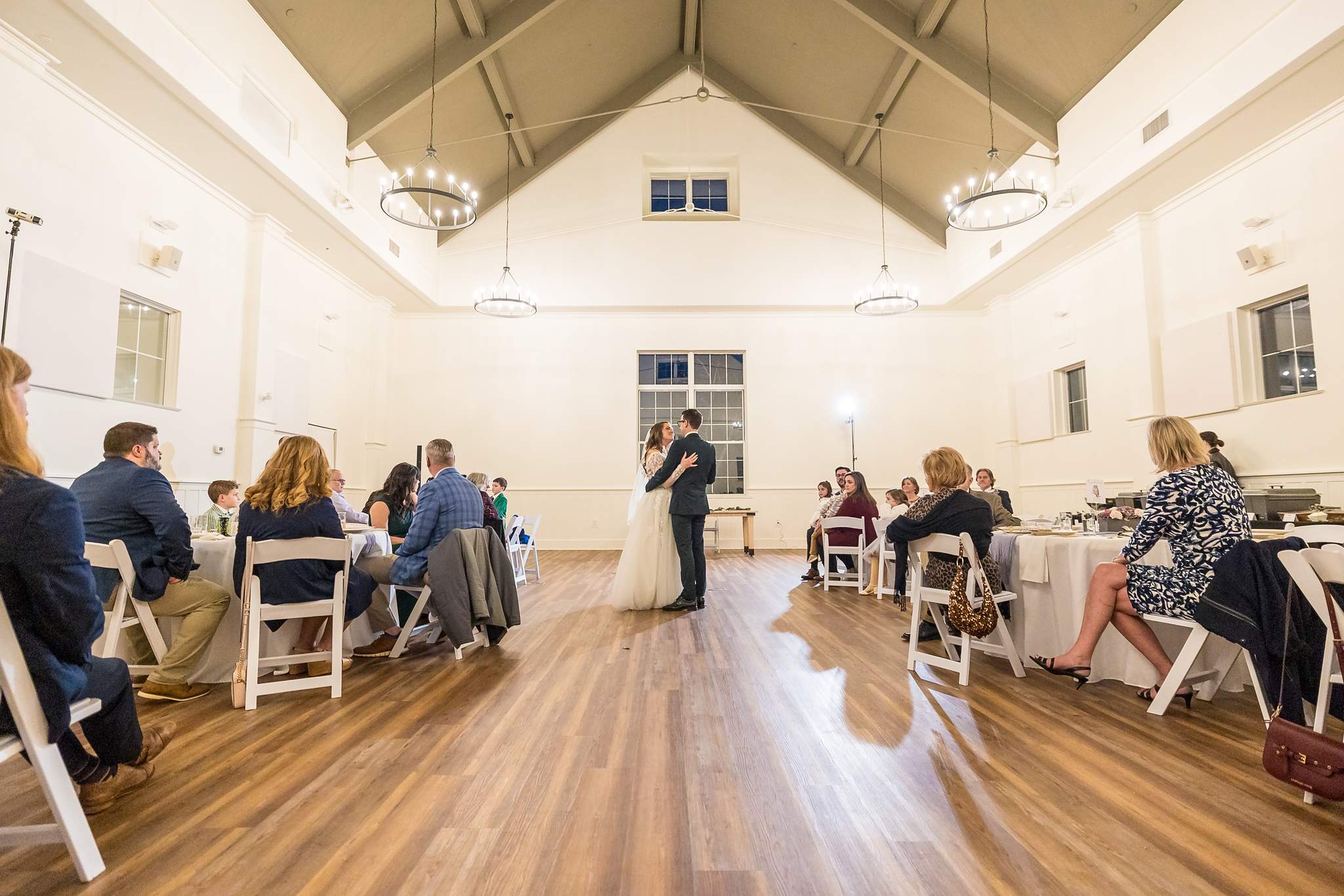 Wide view of the bright event hall at 240 Glynn Street during a wedding reception
