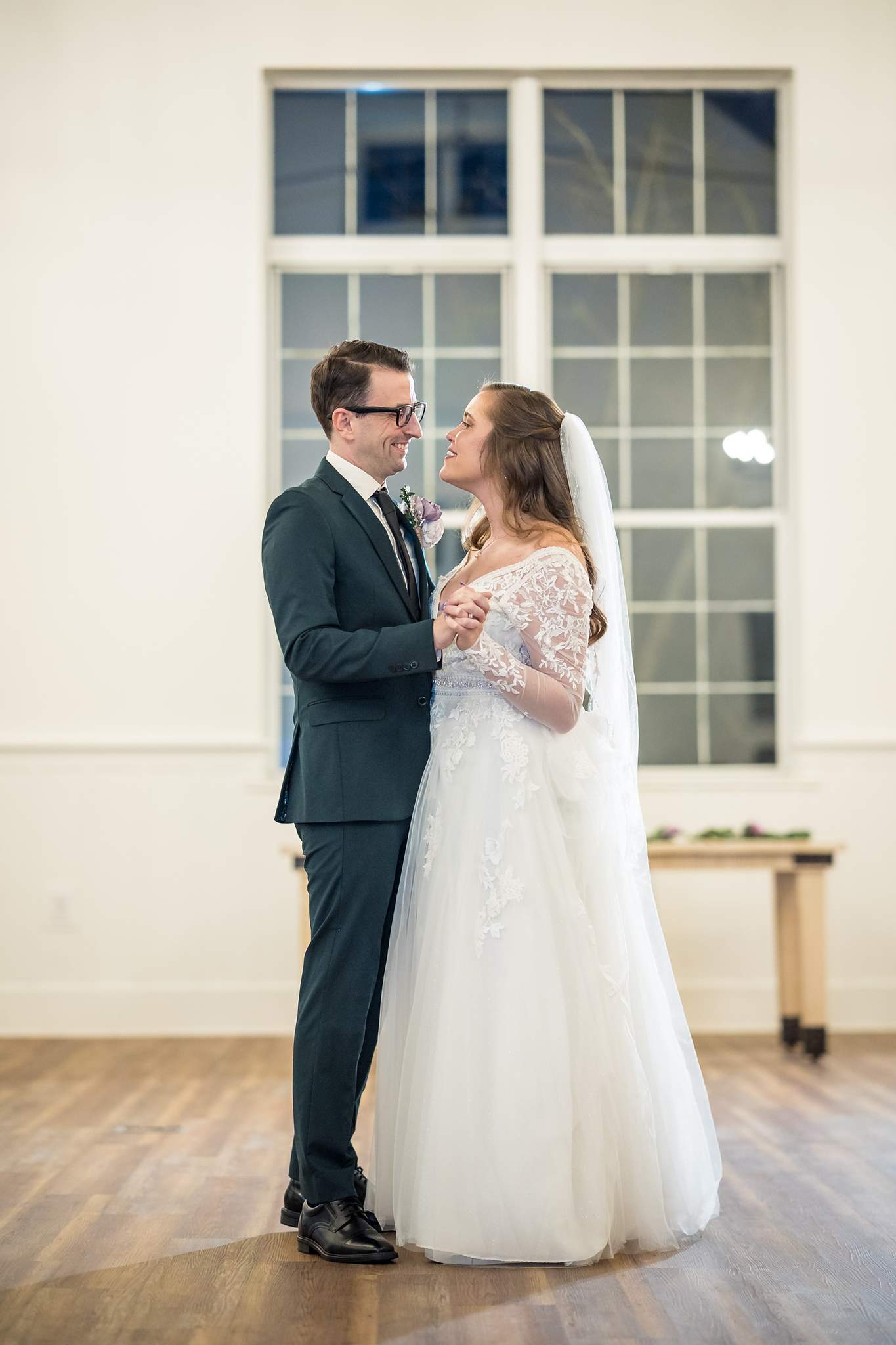 Couple dancing by the tall windows at 240 Glynn Street