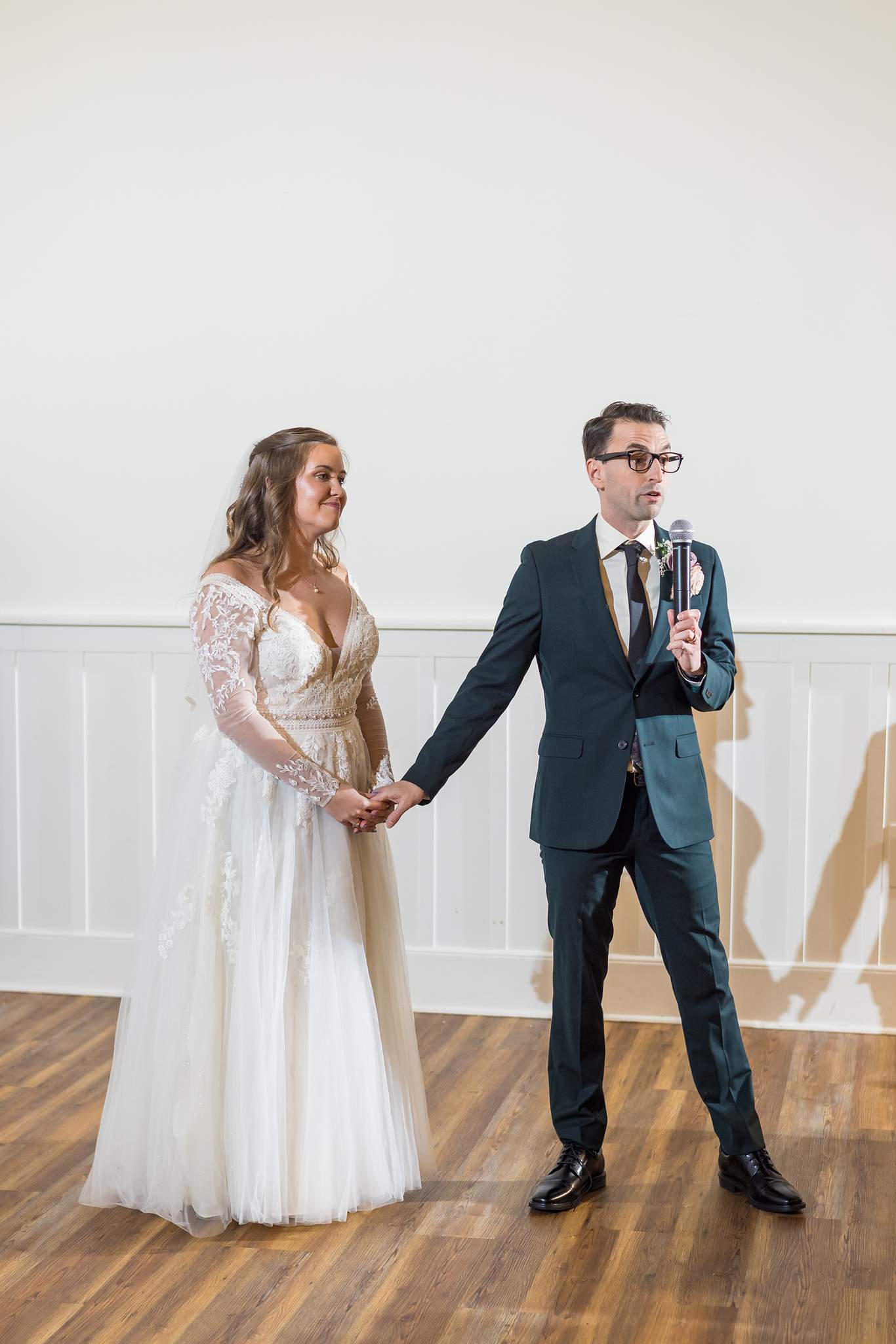 Couple holding hands on the wood floor at 240 Glynn Street