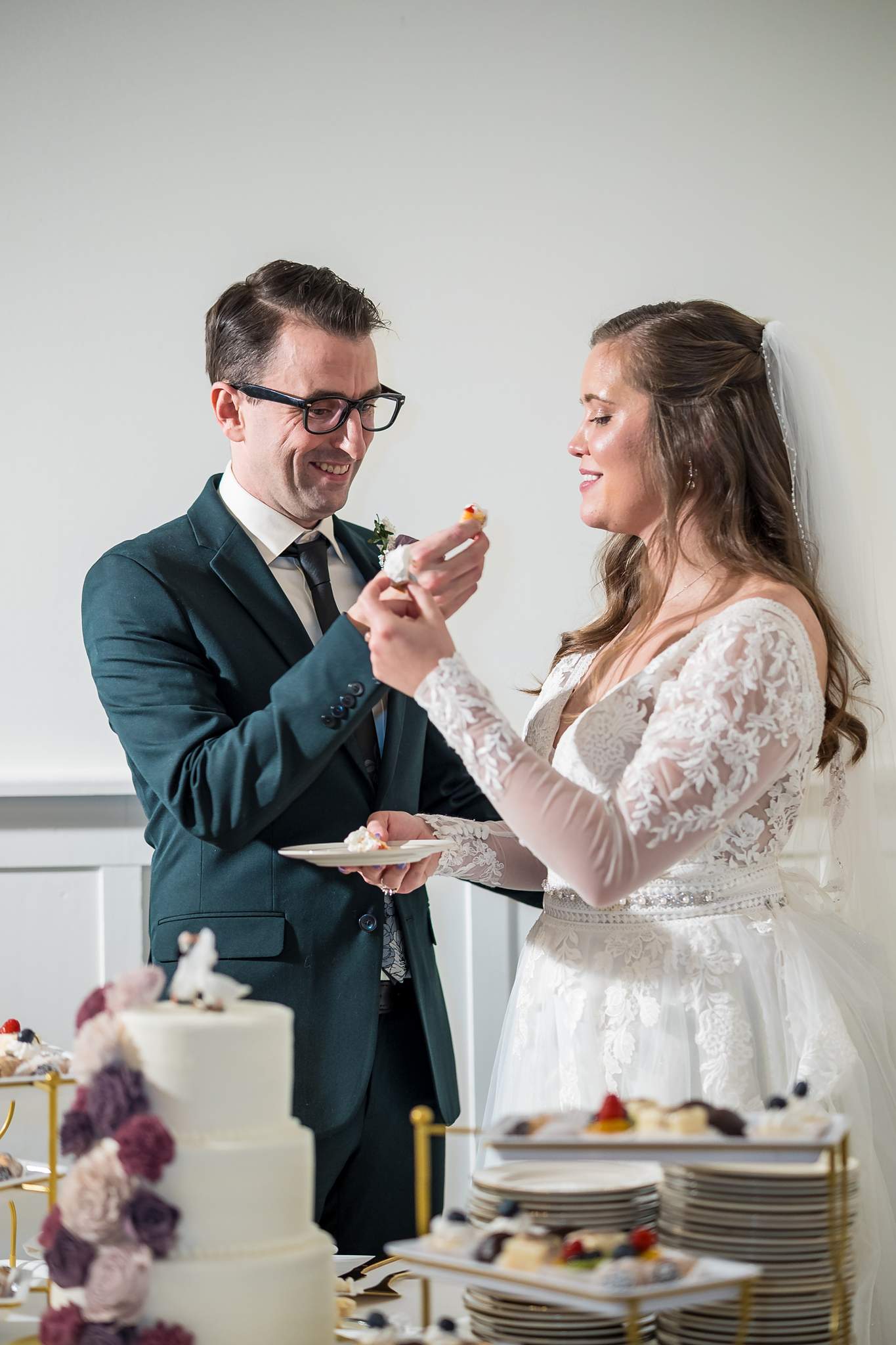 Couple sharing cake at a 240 Glynn Street wedding