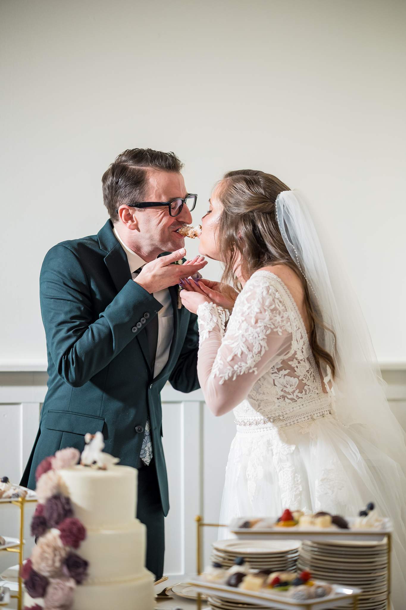 Couple laughing while feeding each other cake at 240 Glynn Street