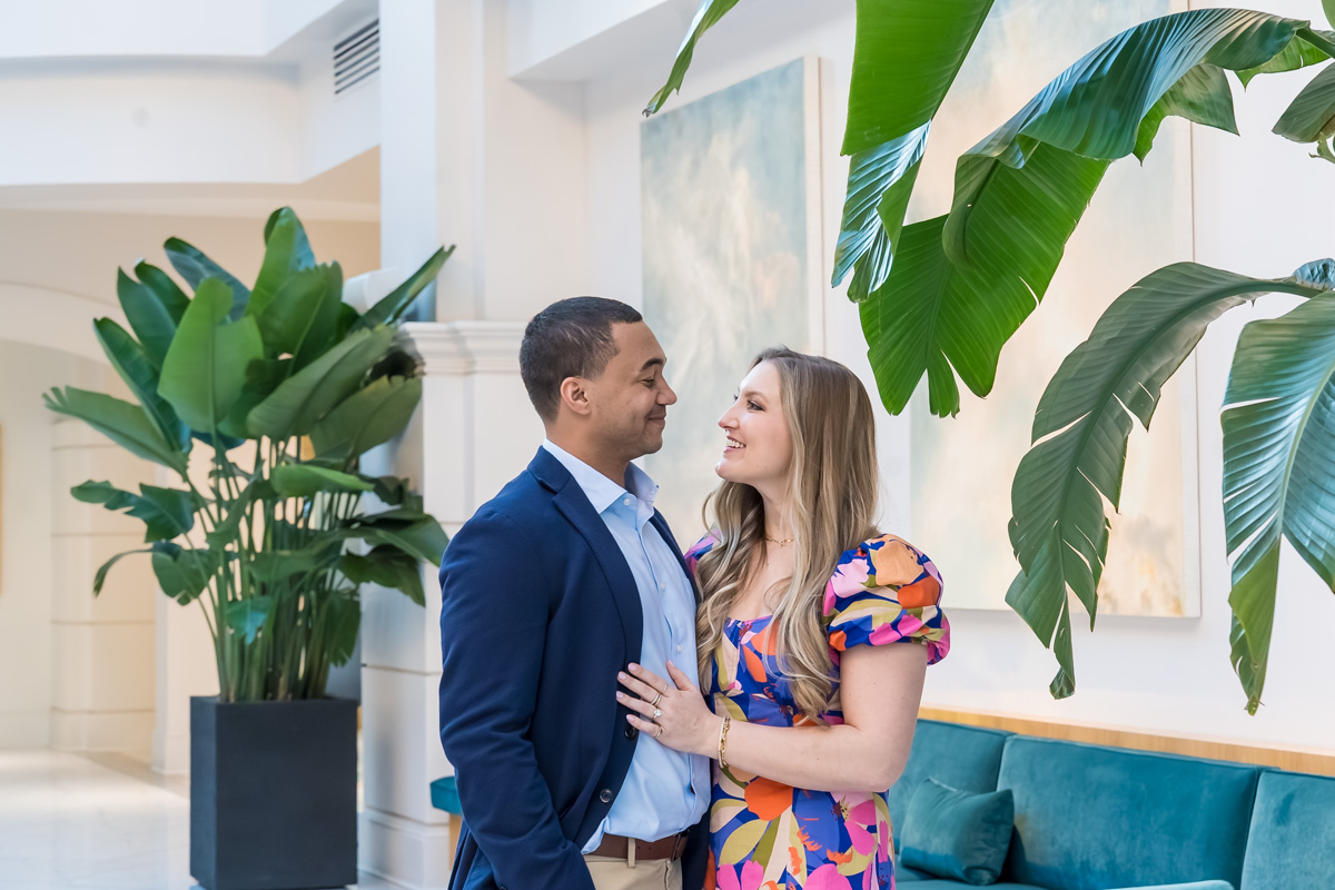 Chateau Elan Proposal photos between palm trees inside the Atrium at the main hotel lobby area