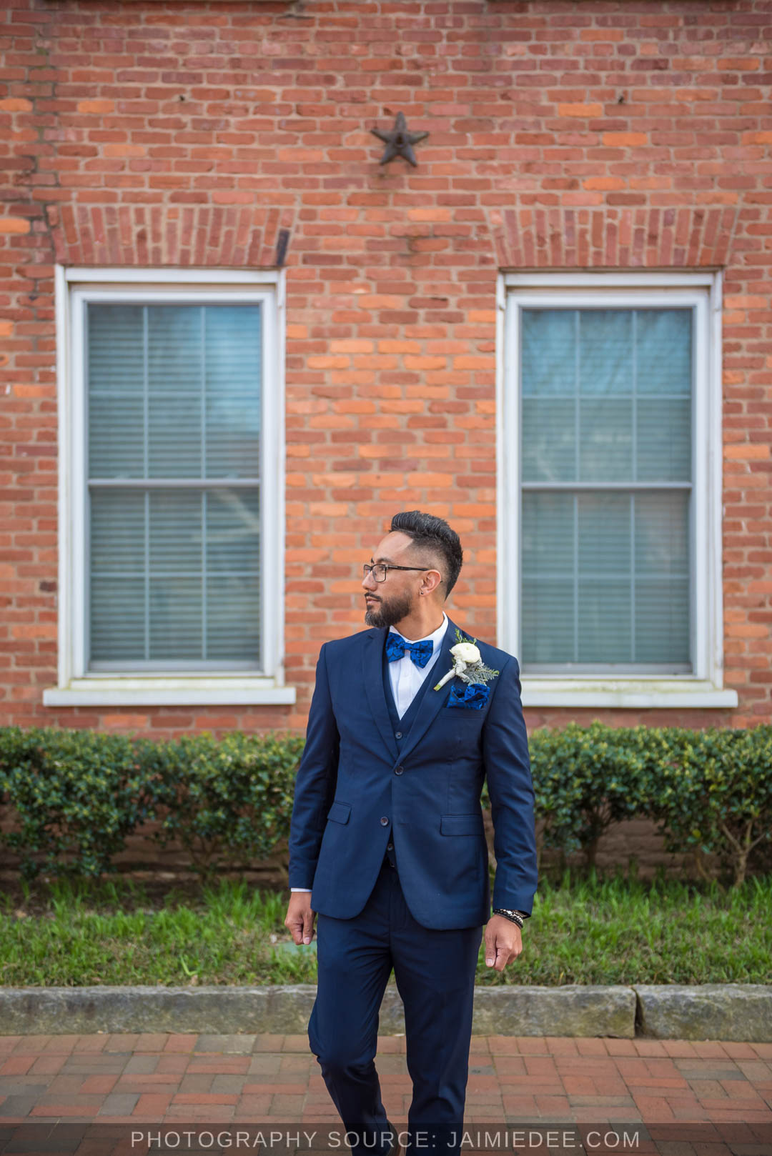Groom in a navy suit and blue bow tie before a Cobb County courthouse wedding