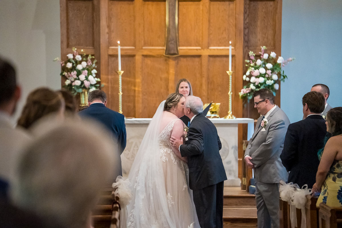 Father of the bride giving away the bride during wedding ceremony at The Episcopal Church of the Epiphany