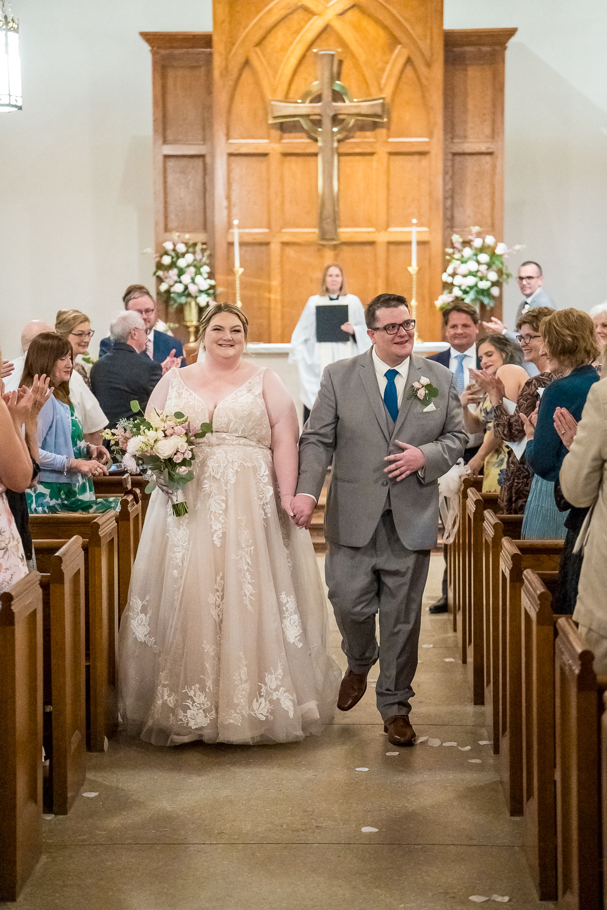 Bride and Groom walking down the aisle after first kiss during wedding ceremony at The Episcopal Church of the Epiphany