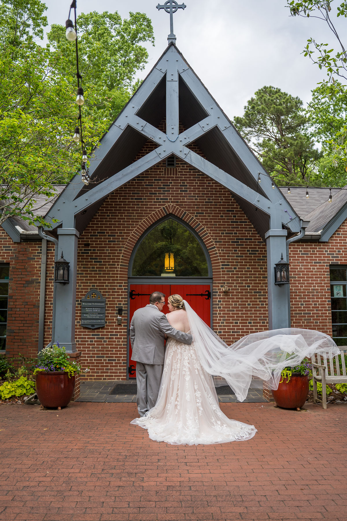 Bride and Groom outside the front doors at The Episcopal Church of the Epiphany Wedding
