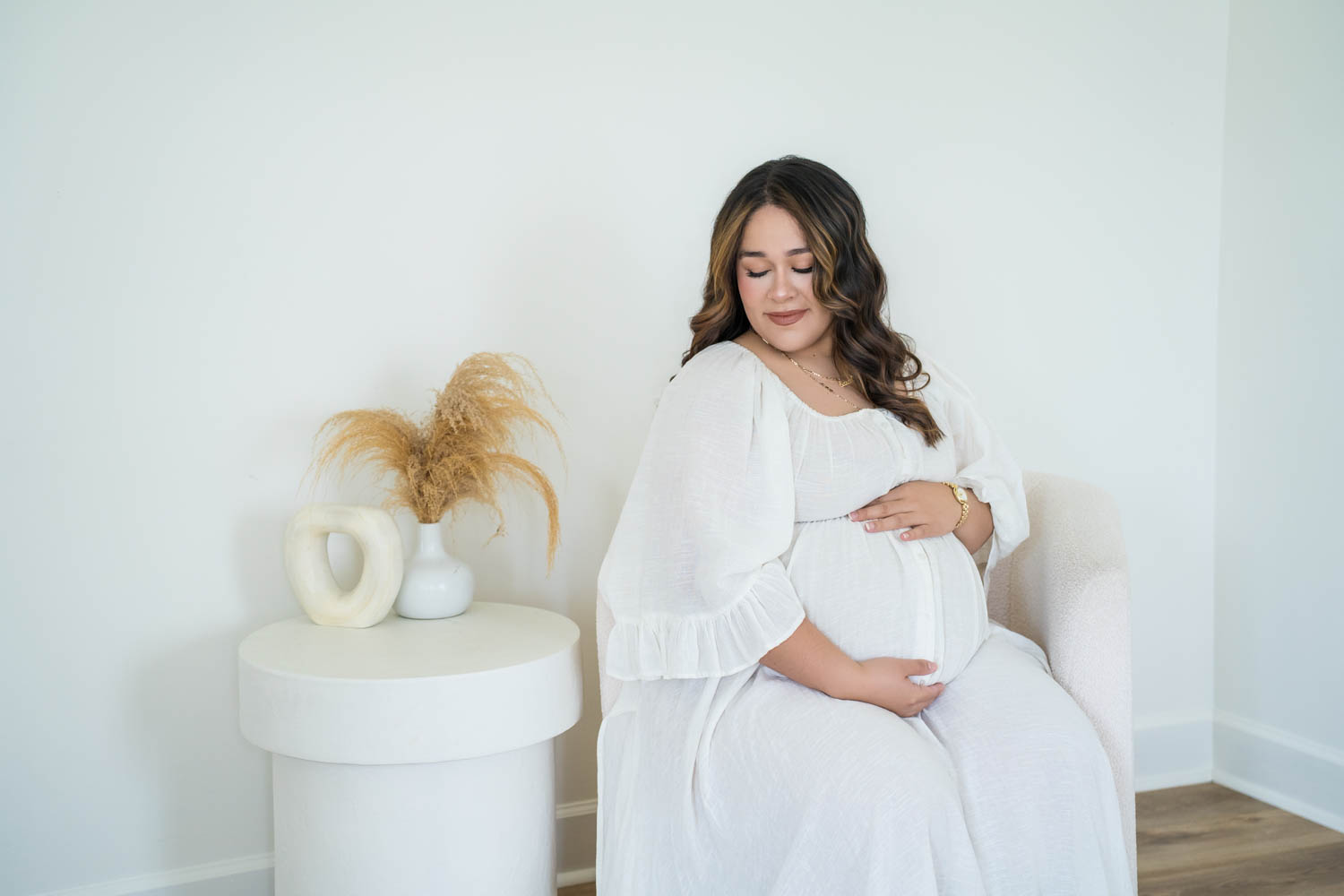Maternity photo in chair corner in the Nest Room in the Farmhouse at Prospect Farms