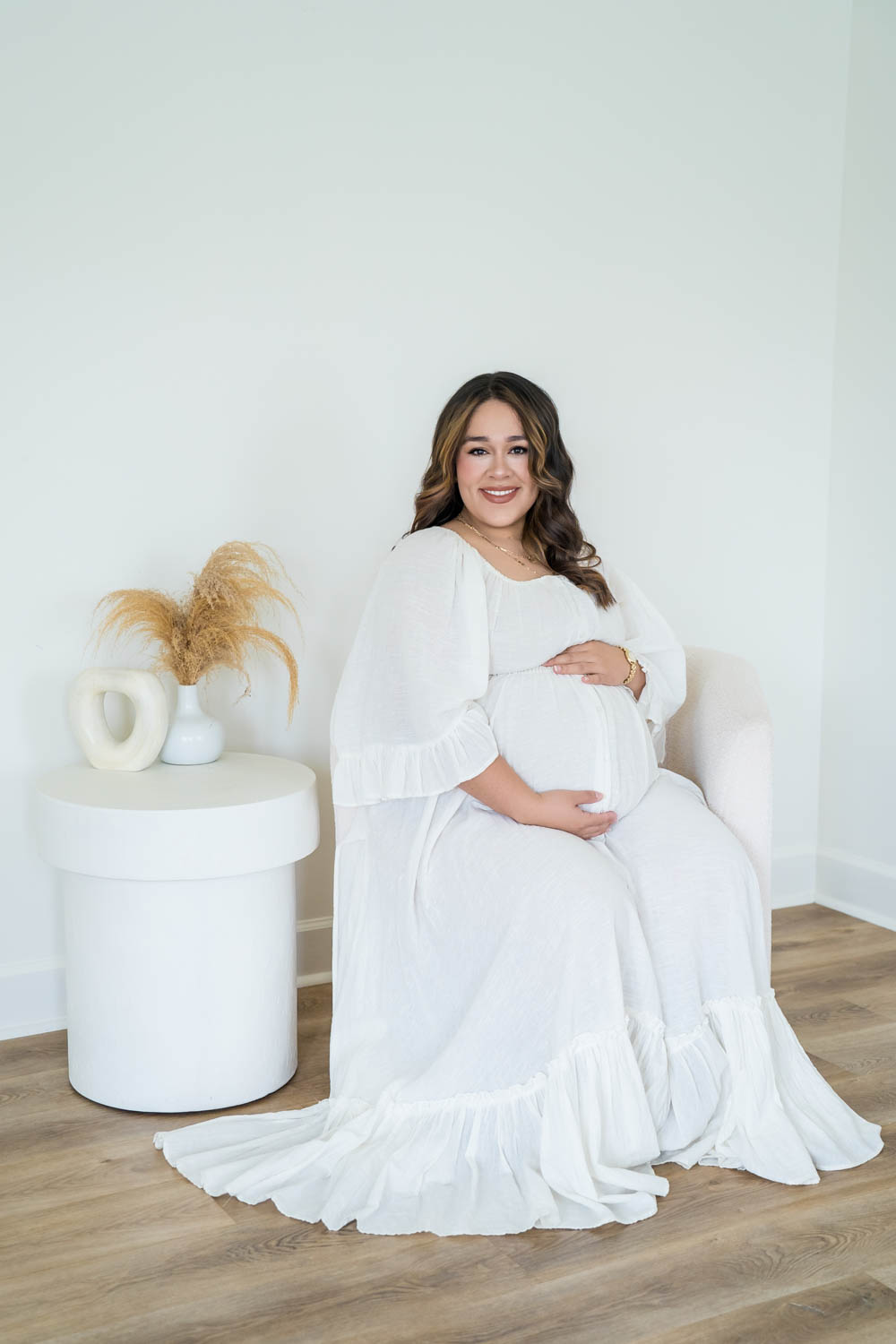 Maternity photo in chair corner in the Nest Room in the Farmhouse at Prospect Farms