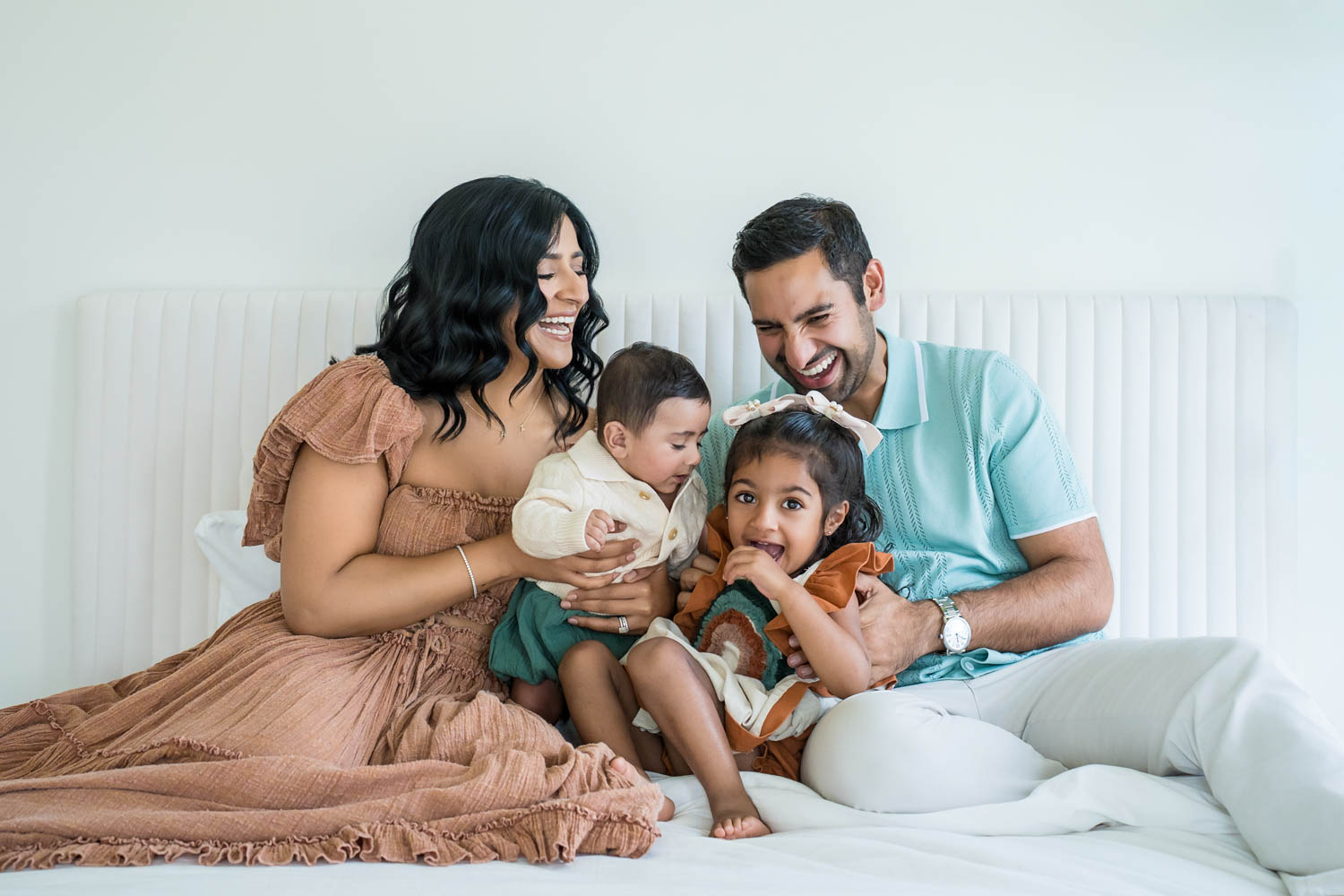 Indian family portrait on the bed in the Nest Room in the Farmhouse at Prospect Farms