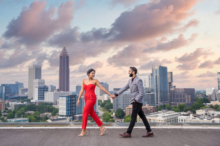 Couple walking on the Ventanas rooftop with the Atlanta skyline behind them Couple walking on the Ventanas rooftop with the Atlanta skyline behind them