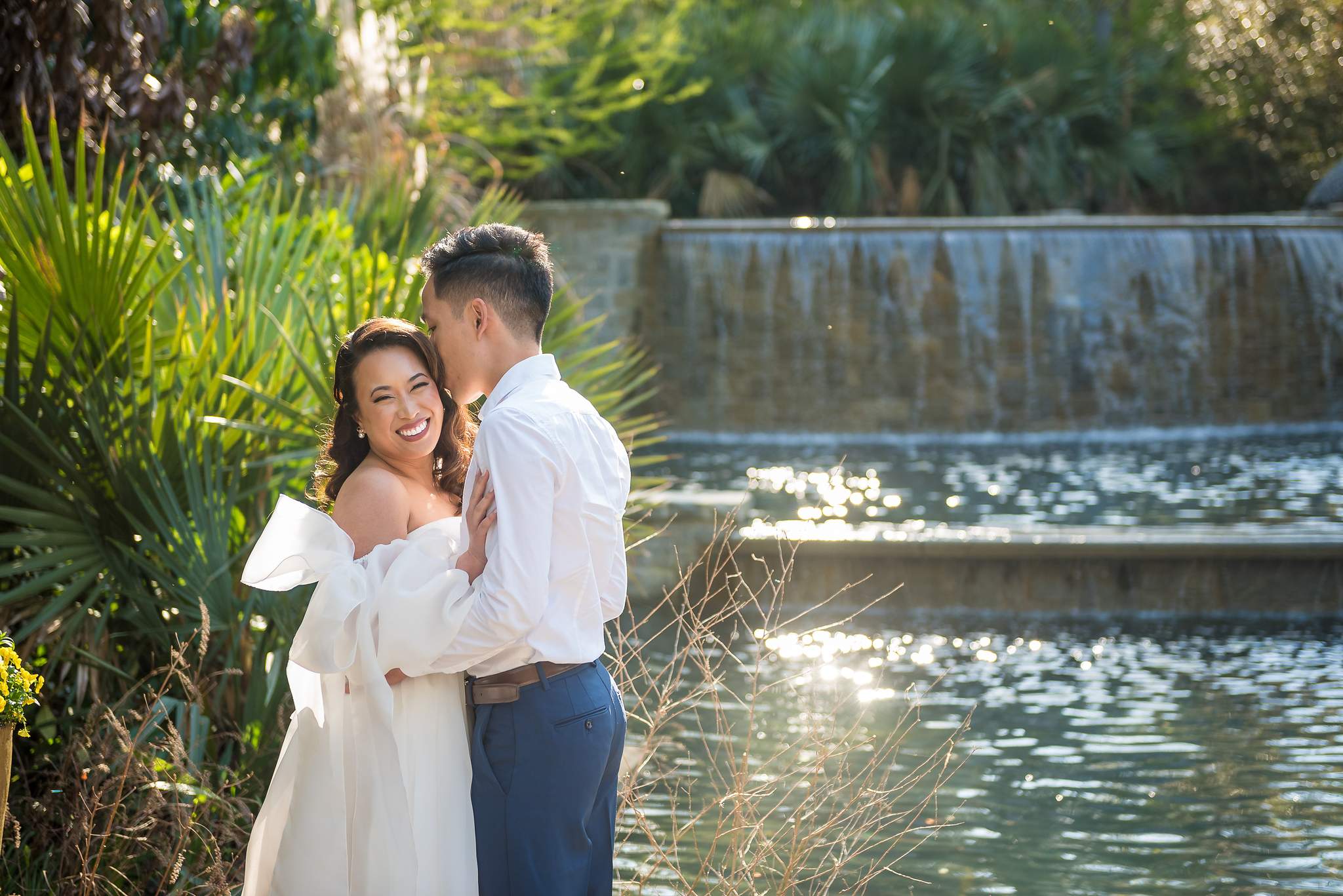 Couple embracing beside the sparkling cascade pool at the Atlanta Botanical Garden