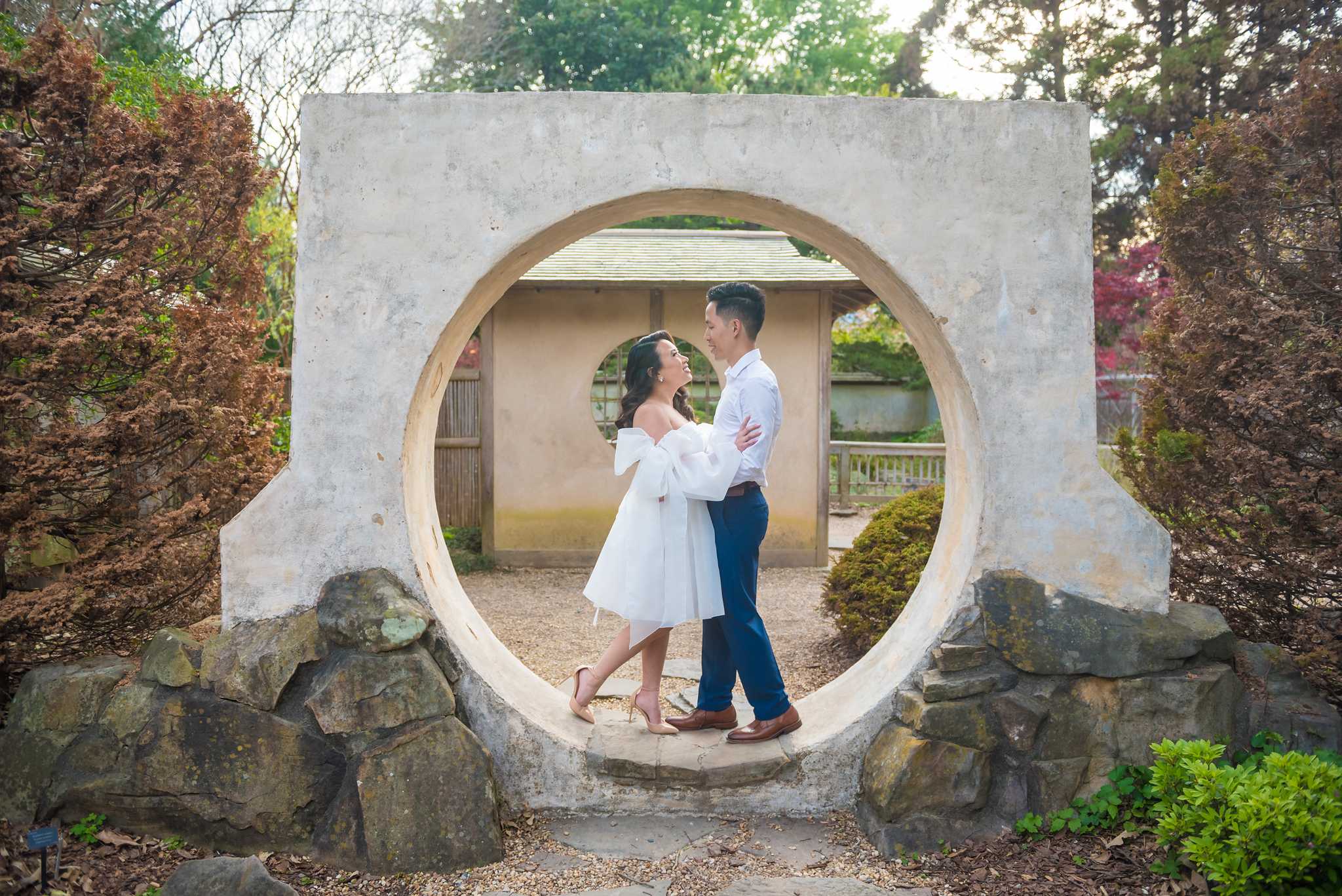Couple framed inside the circular moon gate in the Japanese Garden at the Atlanta Botanical Garden