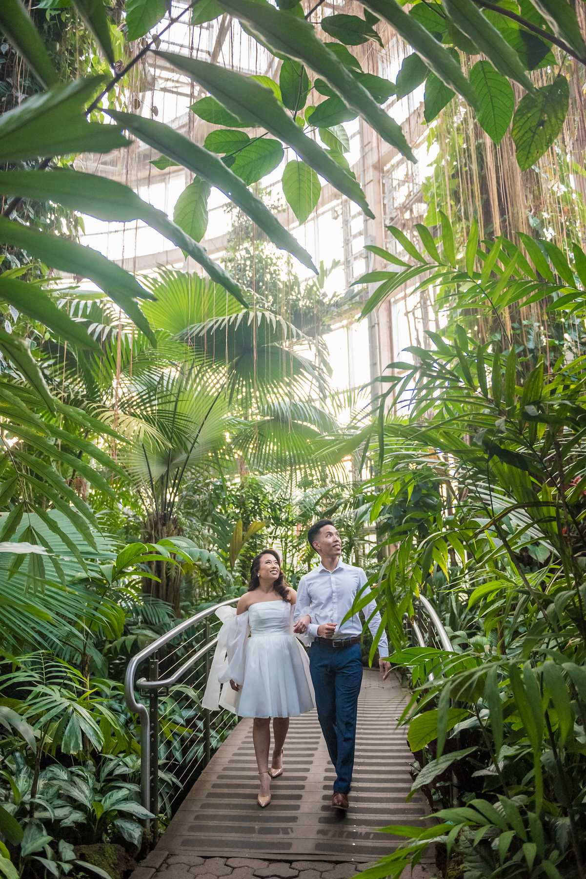 Couple walking down the canopy walkway inside the Fuqua Conservatory