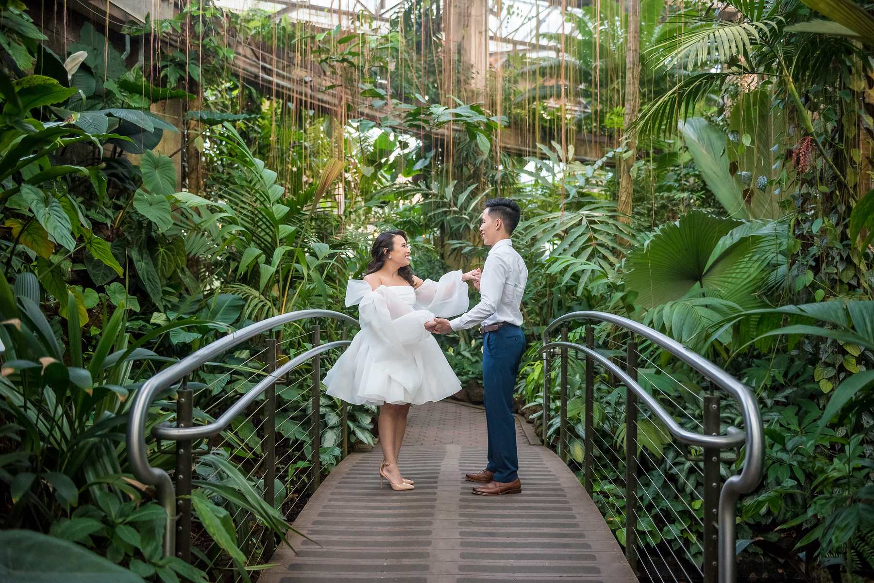 Couple twirling on the canopy bridge high in the Fuqua Conservatory