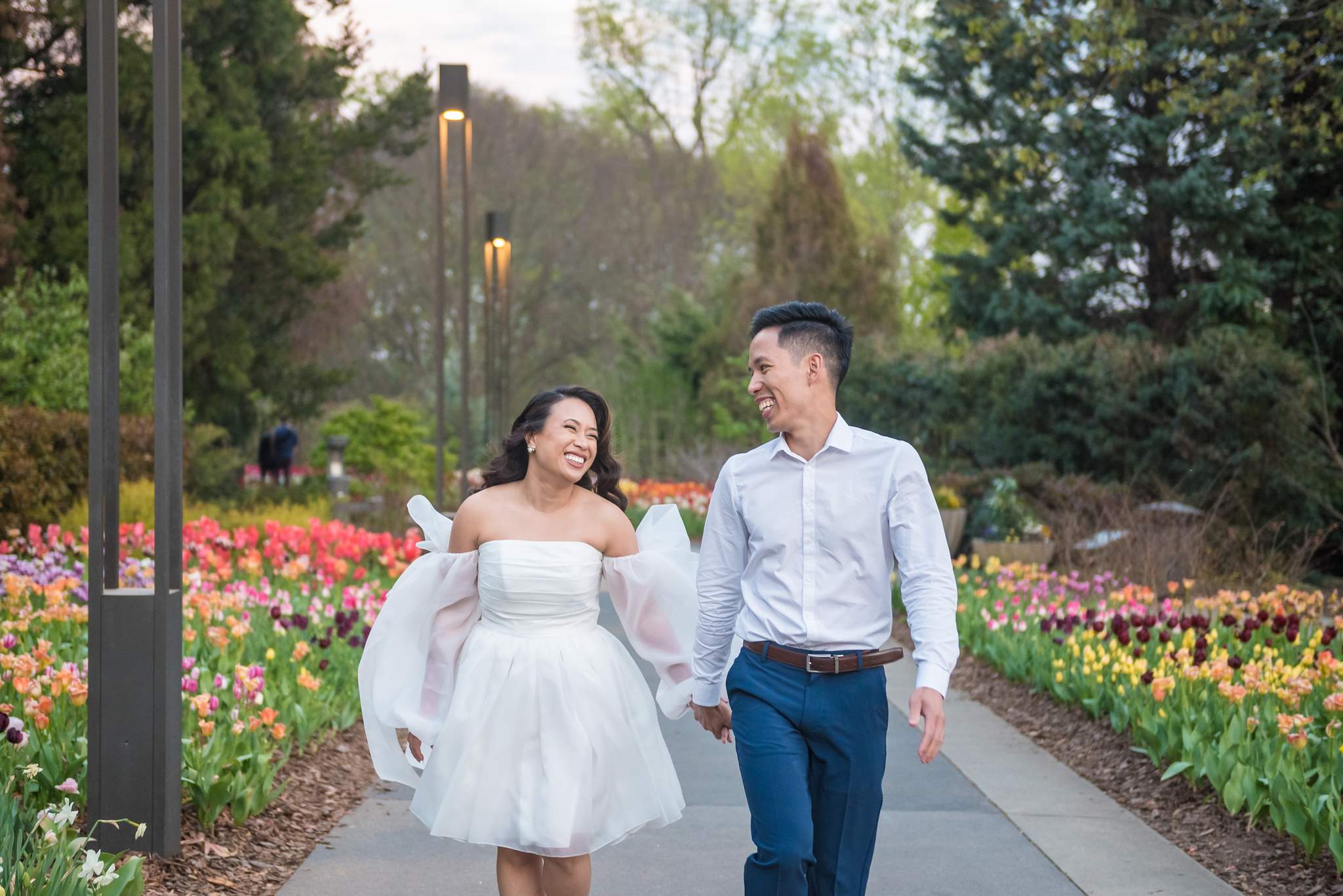 Couple walking along a path lined with spring tulips at the Atlanta Botanical Garden