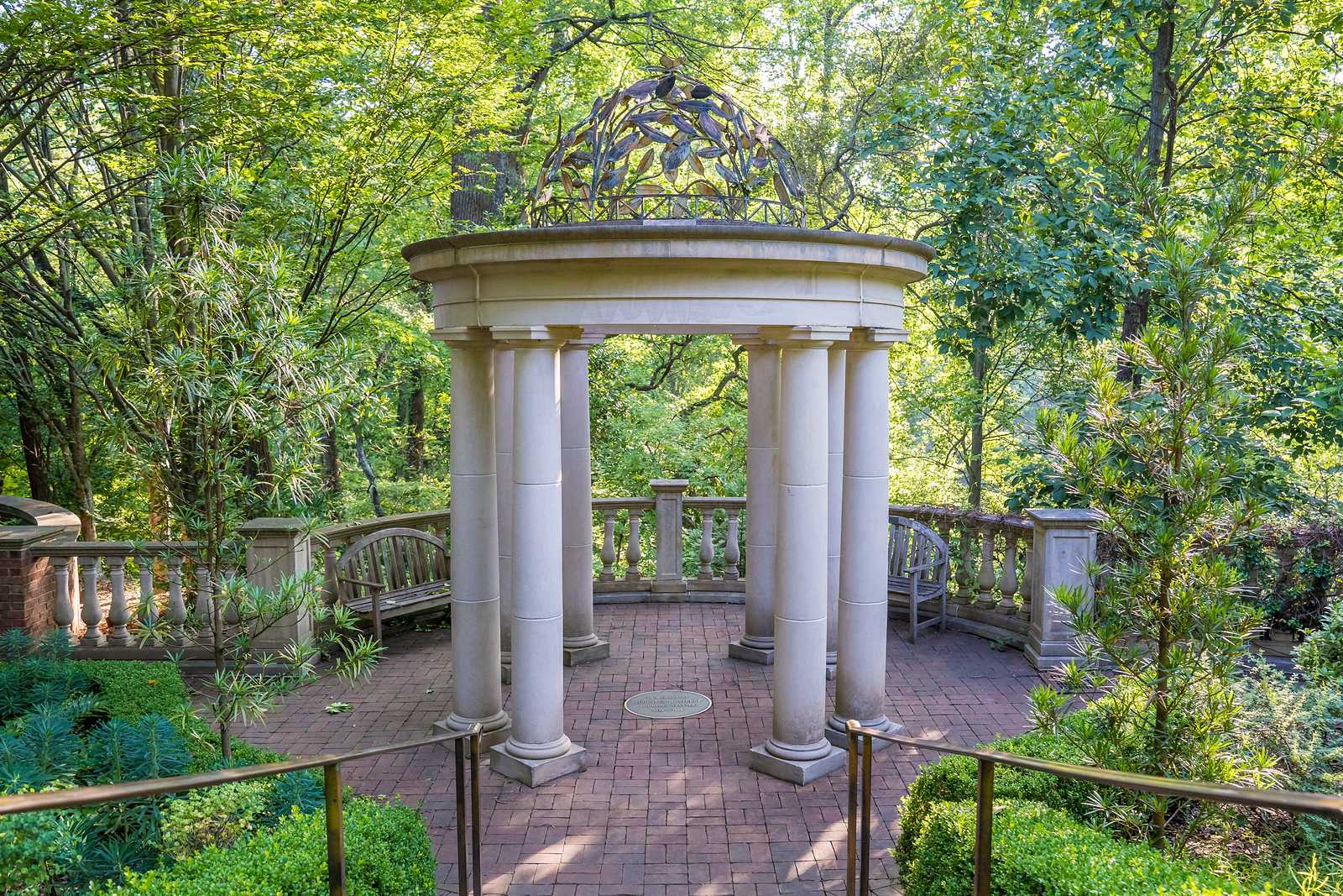 White stone gazebo surrounded by green trees at the Atlanta Botanical Garden, a romantic proposal spot