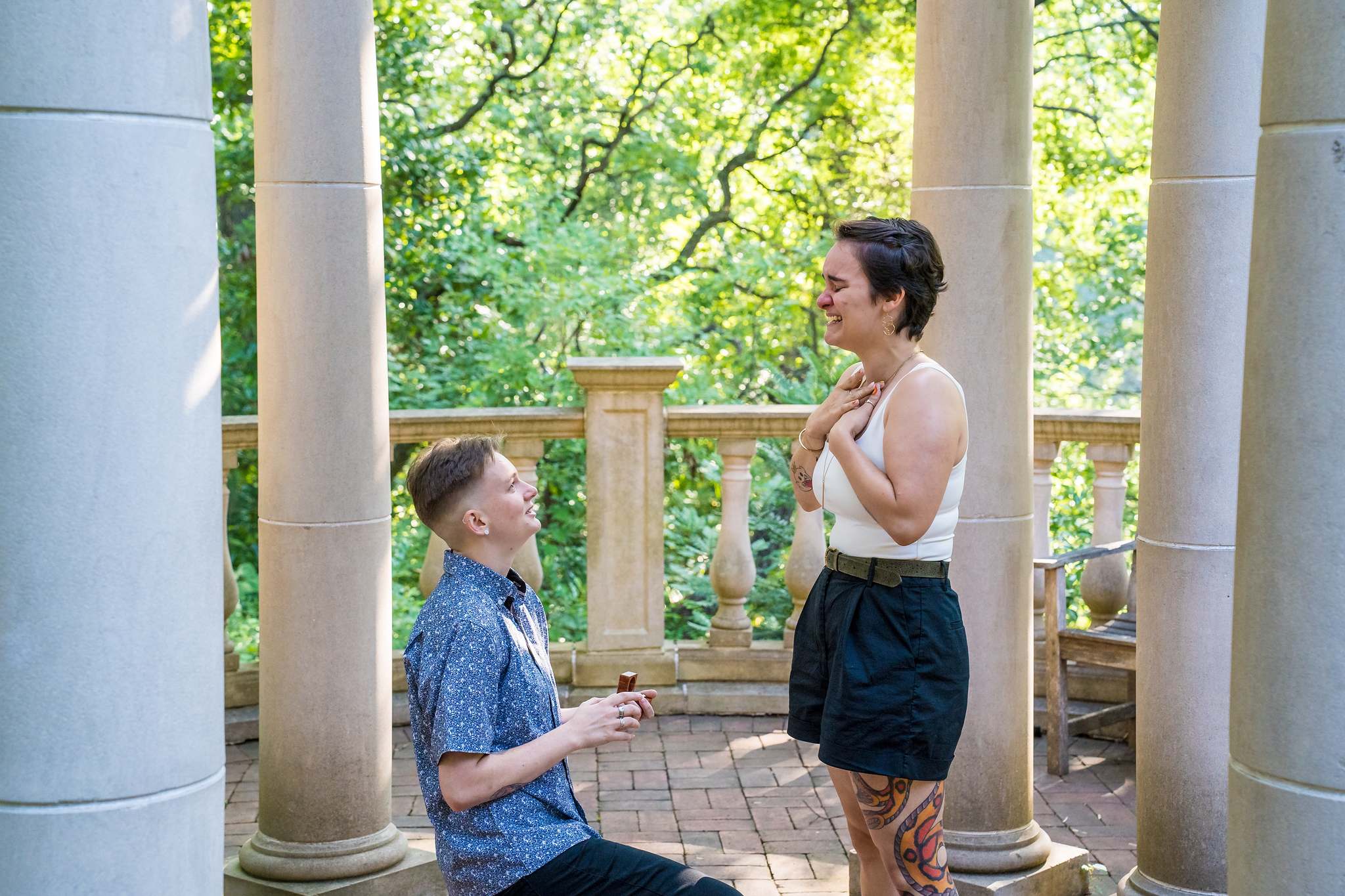 Emotional reaction to a proposal between the stone columns at the Atlanta Botanical Garden
