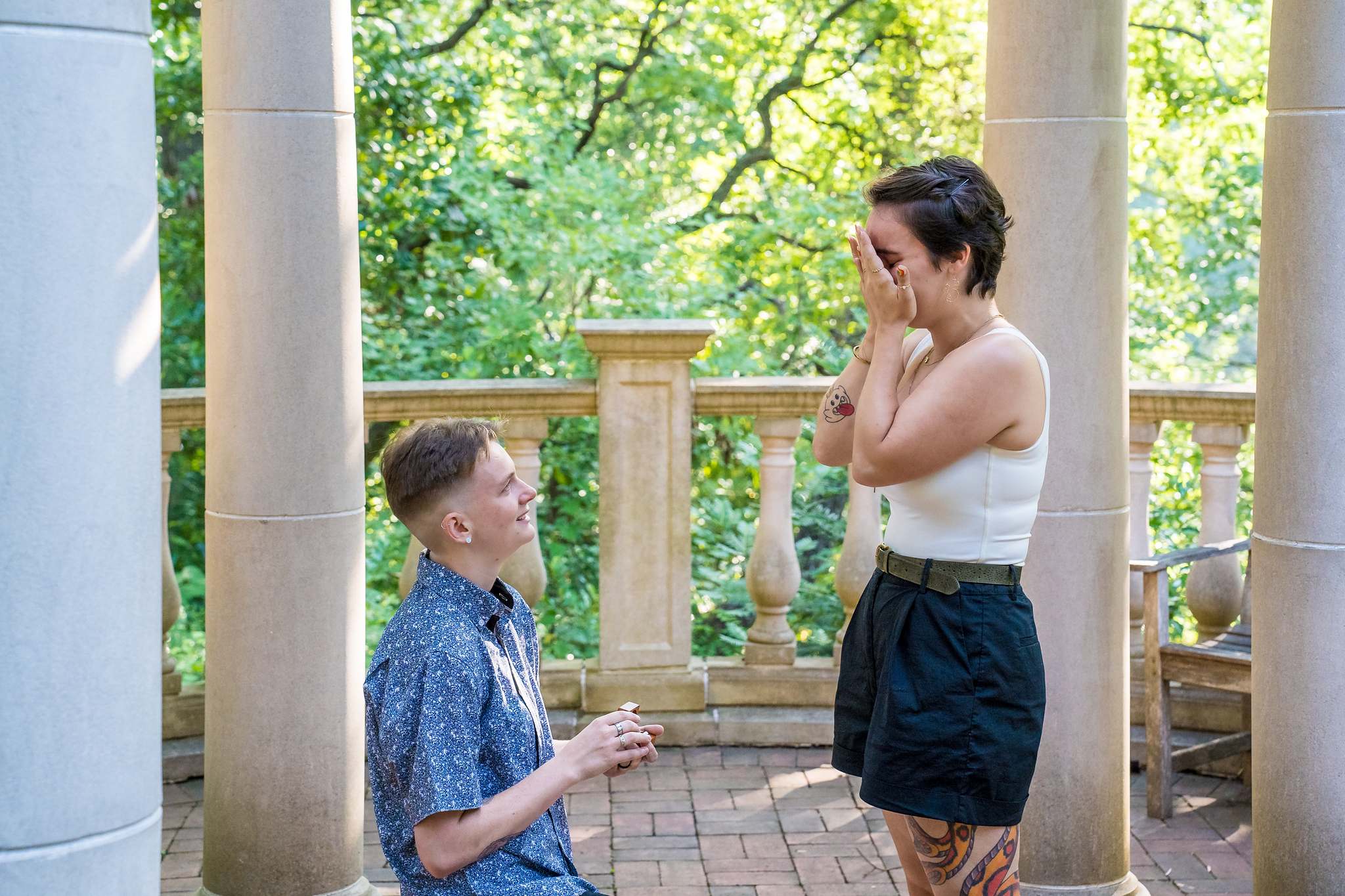 Hands over face in happy tears during a surprise proposal at the Atlanta Botanical Garden