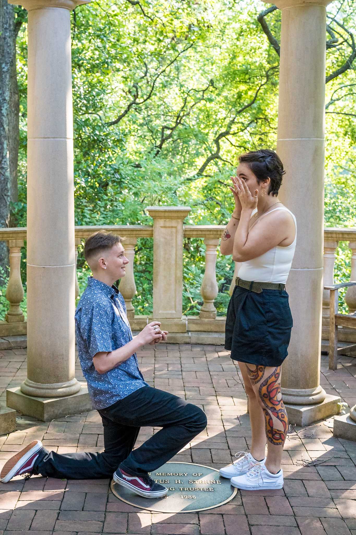 Proposal on one knee with a ring box between the gazebo columns at the Atlanta Botanical Garden