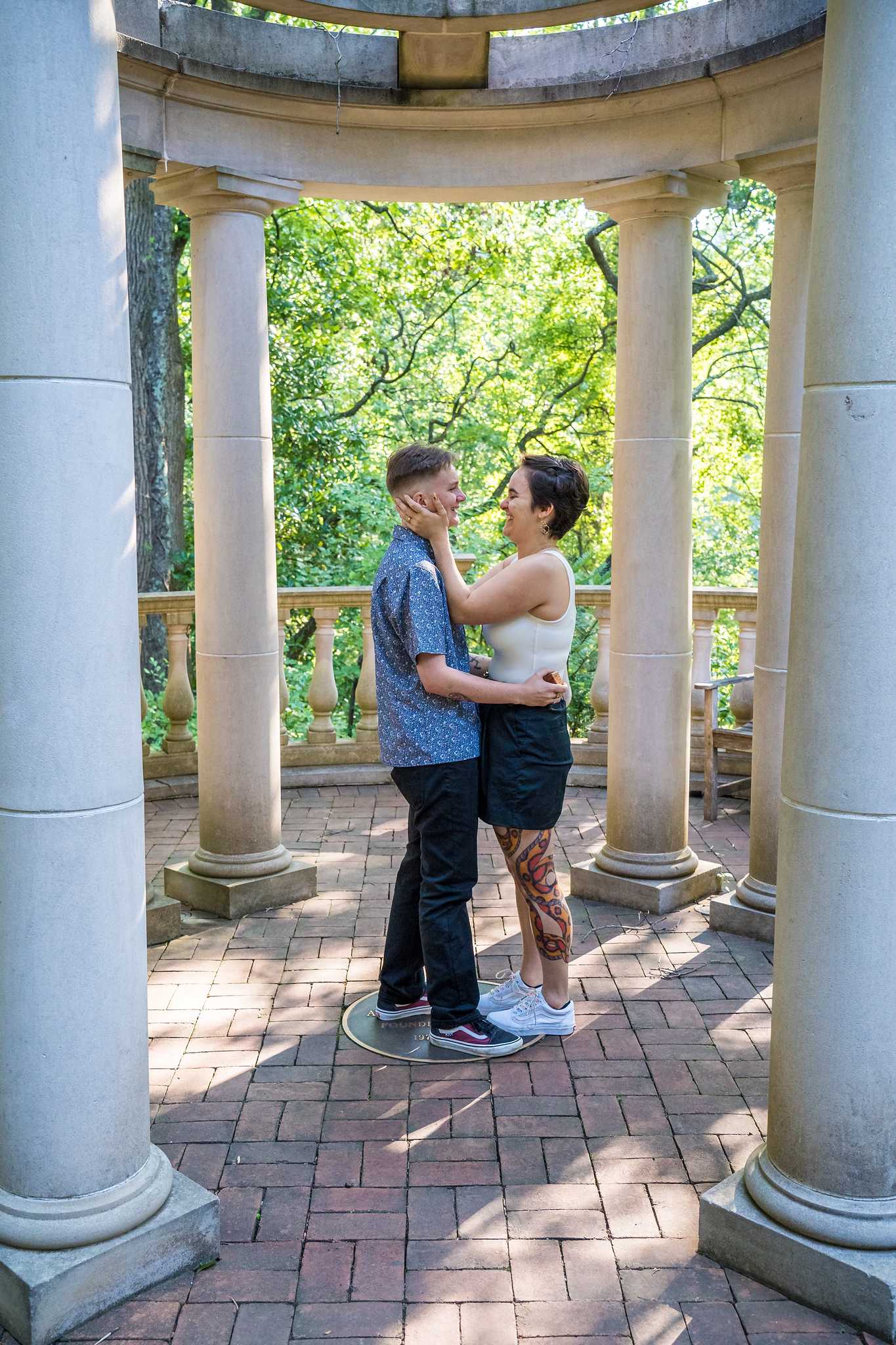 Newly engaged couple embracing inside the domed gazebo at the Atlanta Botanical Garden