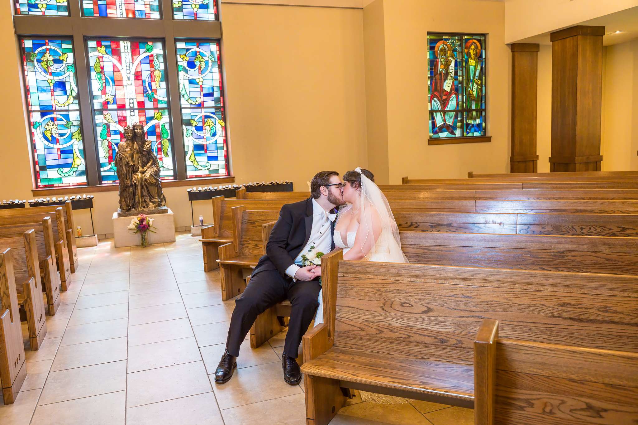 Couple sharing a quiet moment in a small chapel with stained glass windows in Atlanta