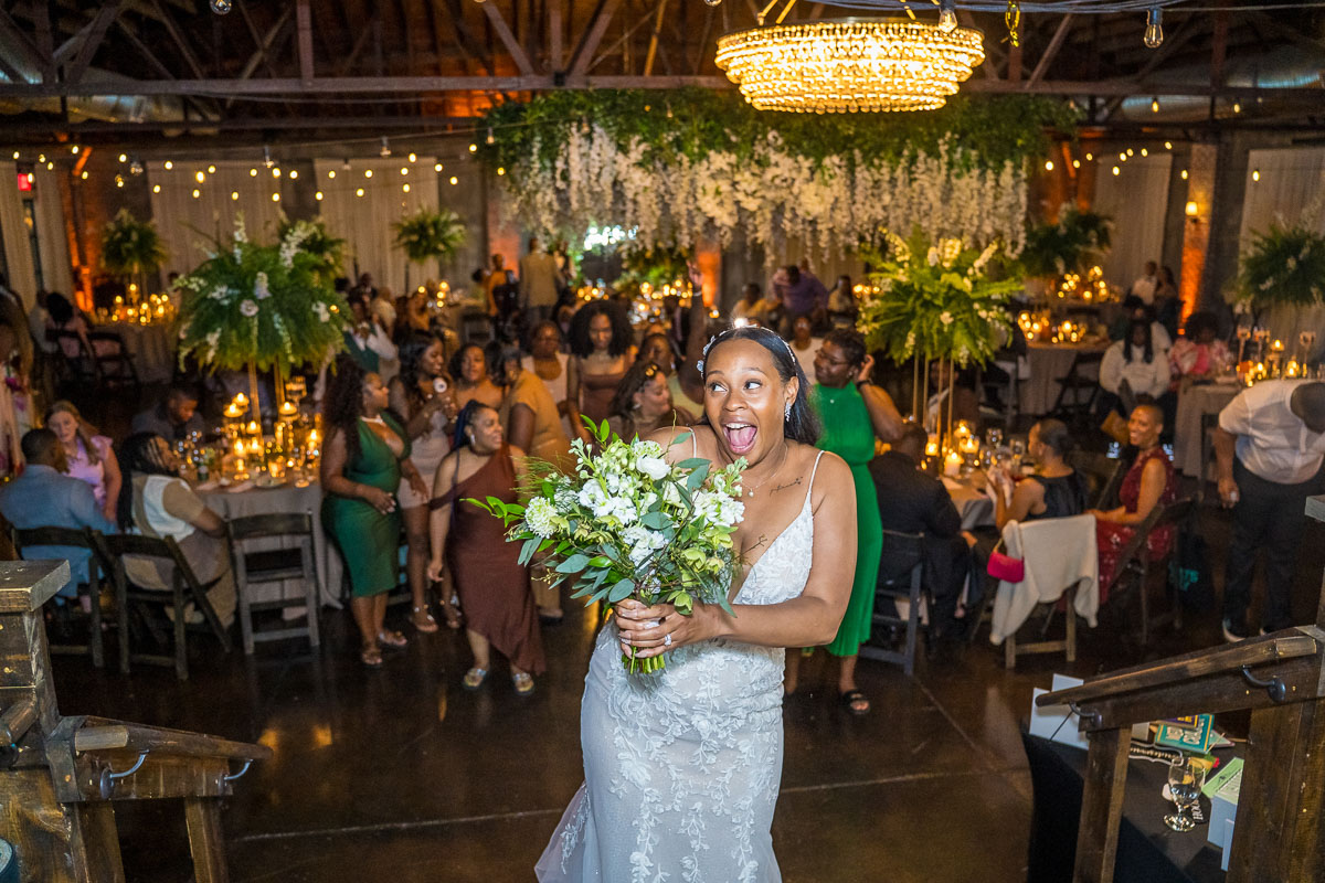 Black wedding photography at night - bouquet toss