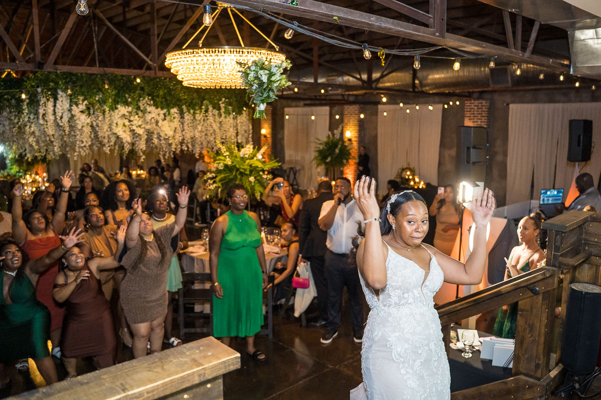 Black wedding photography at night - bouquet toss