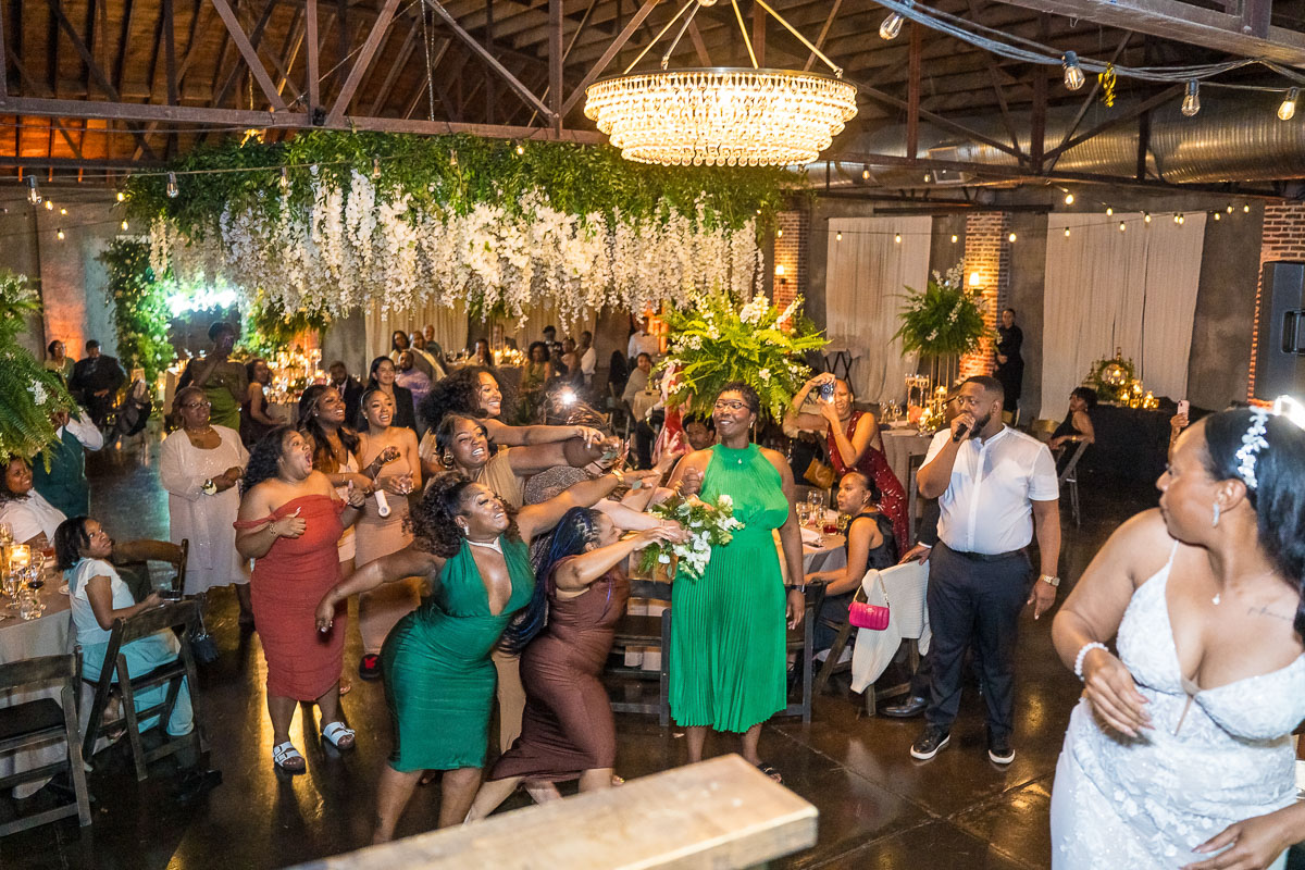Black wedding photography at night - bouquet toss