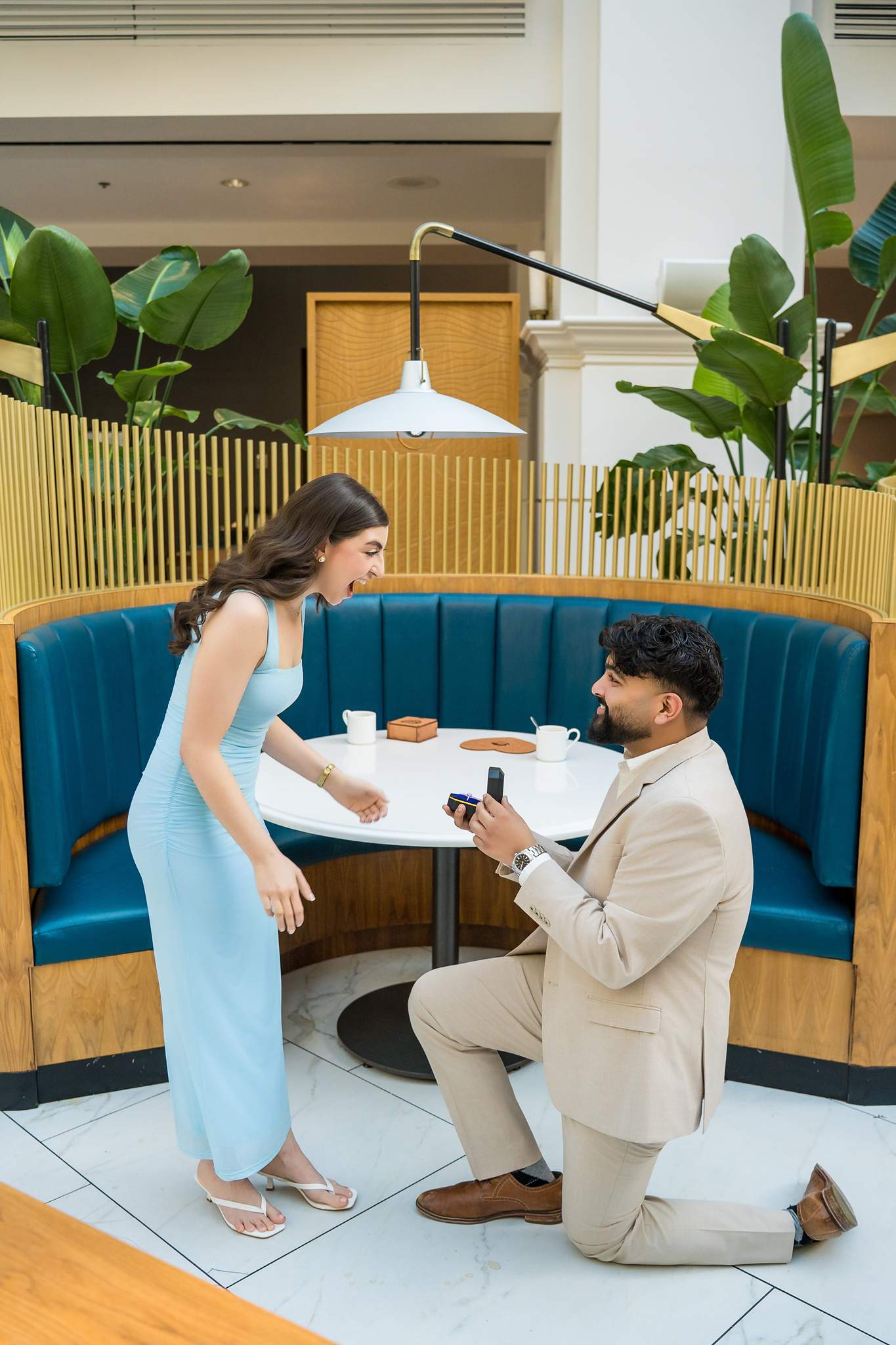 Proposal on one knee at a round table in the Chateau Elan lounge