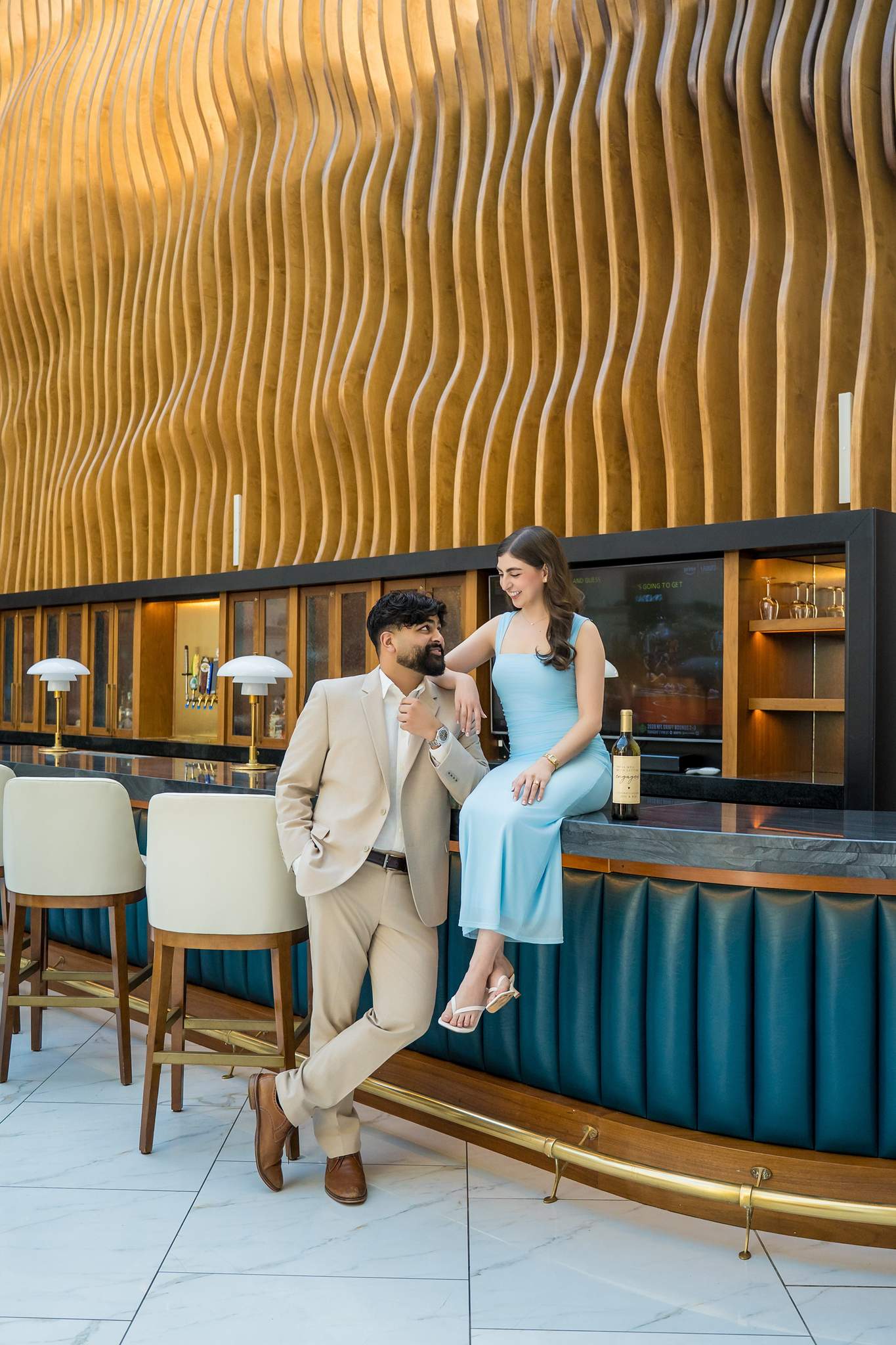 Newly engaged couple at the bar under the curved wood ceiling at Chateau Elan