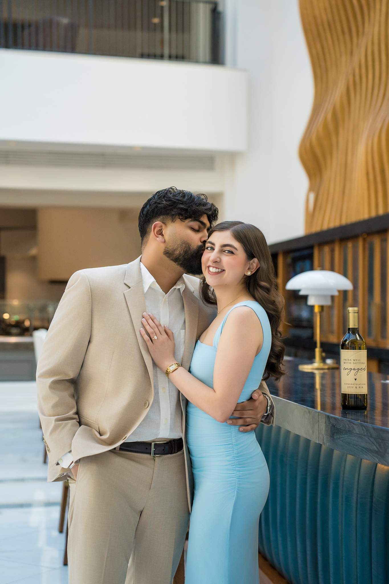 Engaged couple close together in the Chateau Elan bar after the proposal