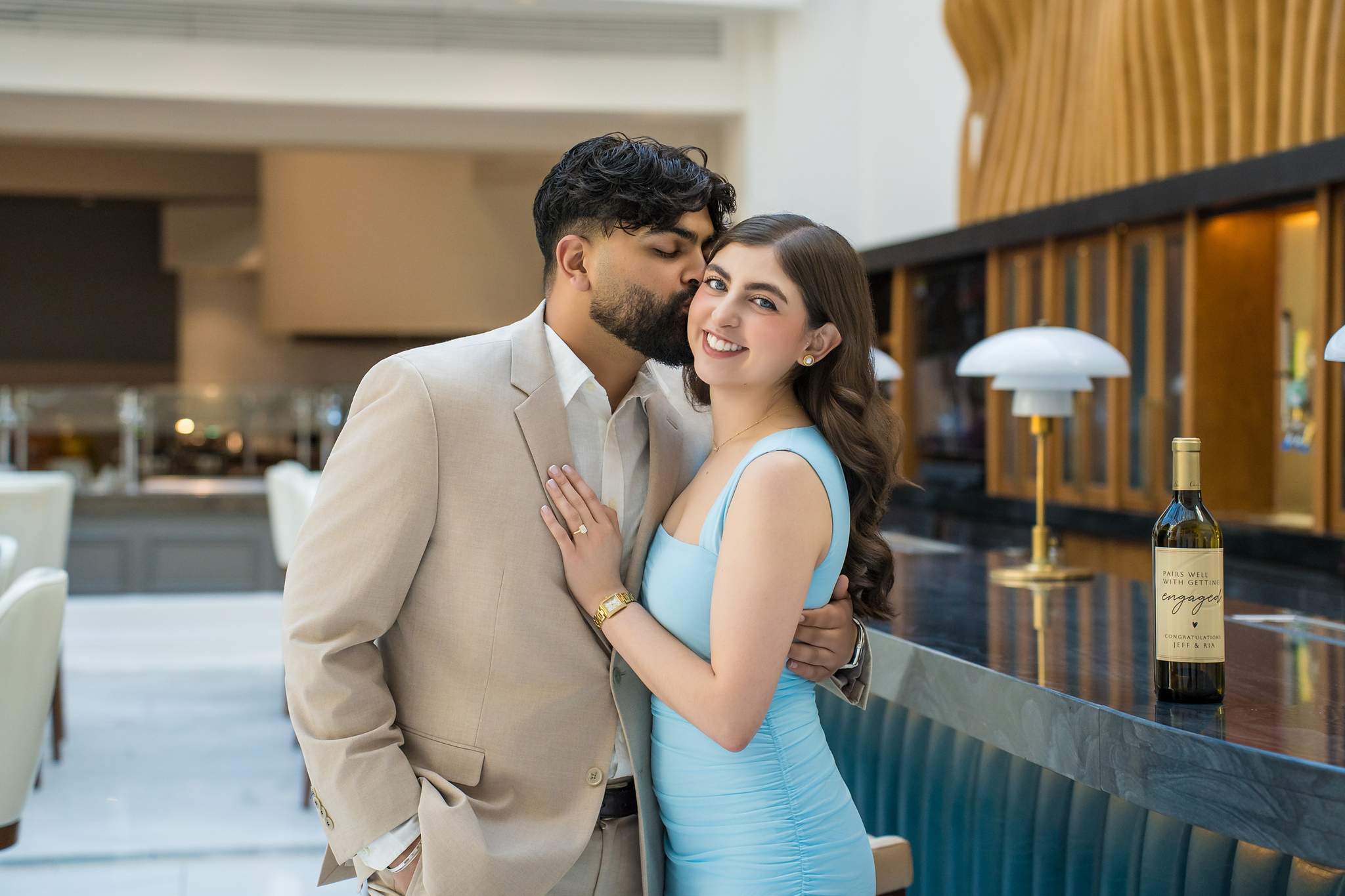 Couple kissing in the Chateau Elan bar after saying yes