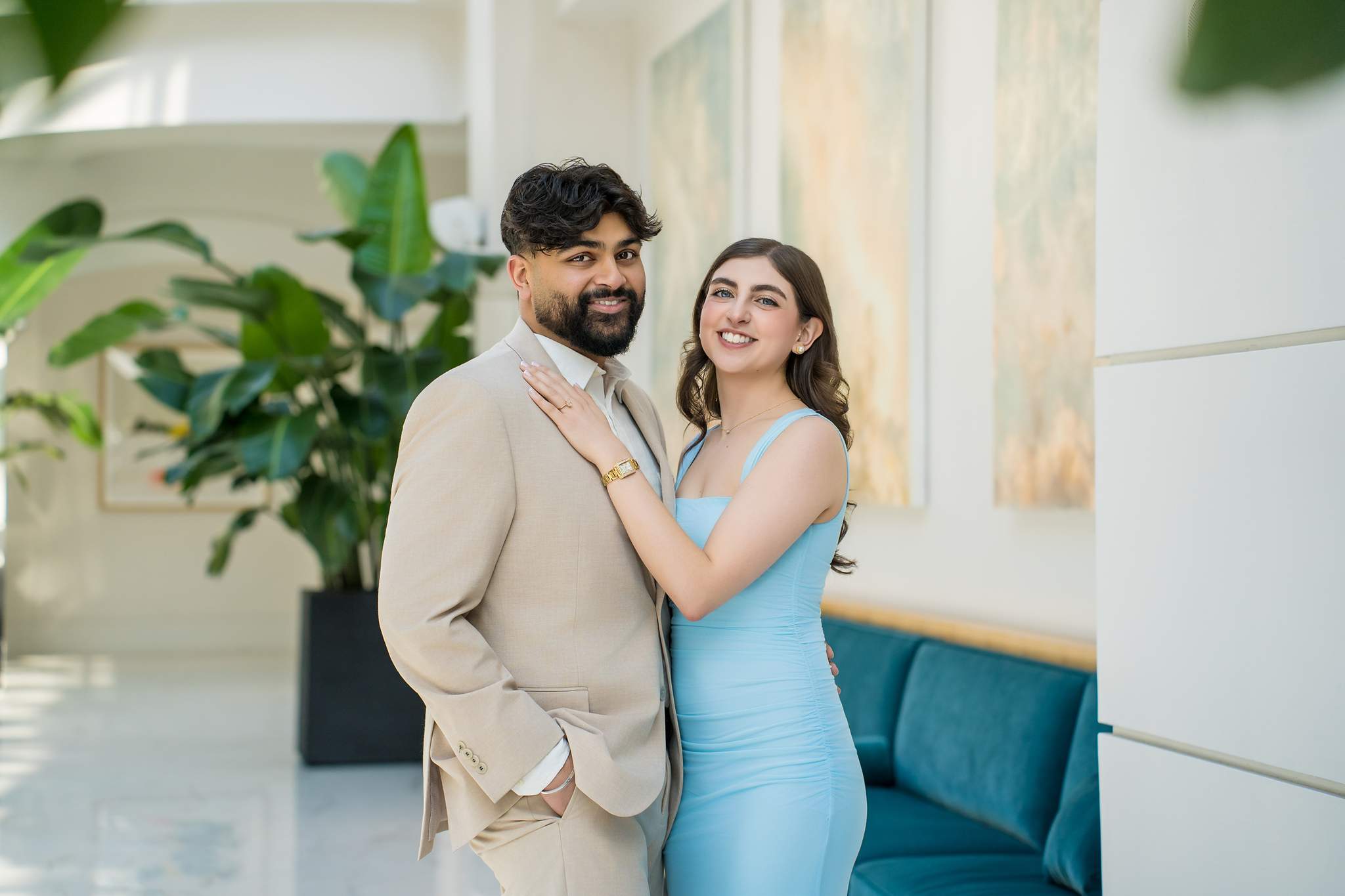 Couple smiling among tropical plants in the bright Chateau Elan atrium