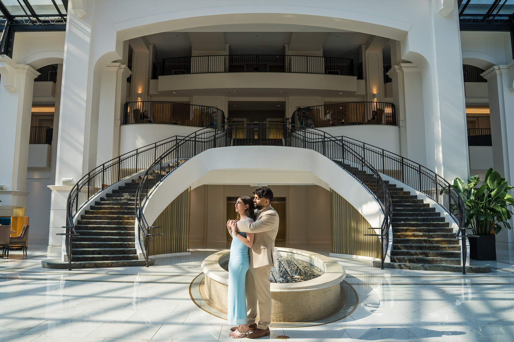 Couple by the fountain beneath the grand staircase inside Chateau Elan