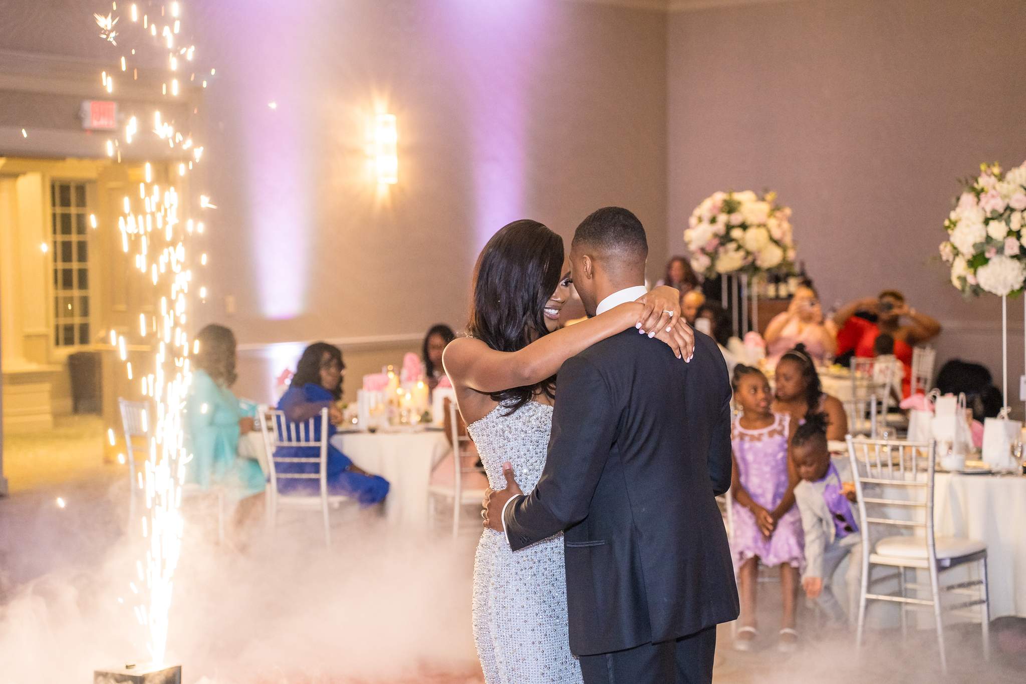 Cold spark fountains glow beside the bride and groom during their first dance