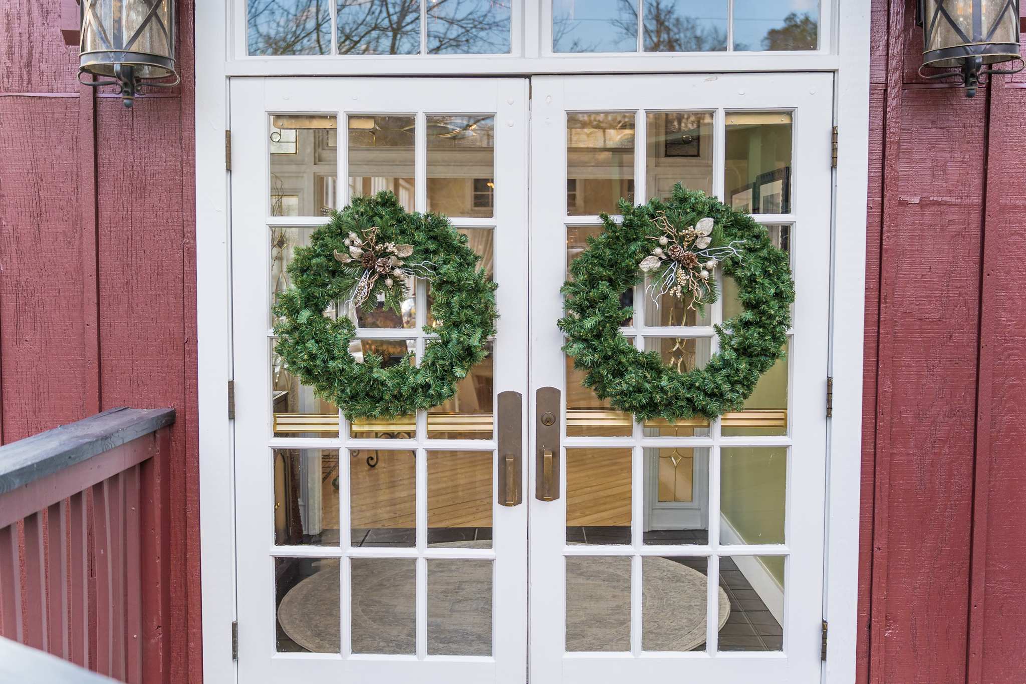 Christmas wreaths on white French doors at a December wedding venue