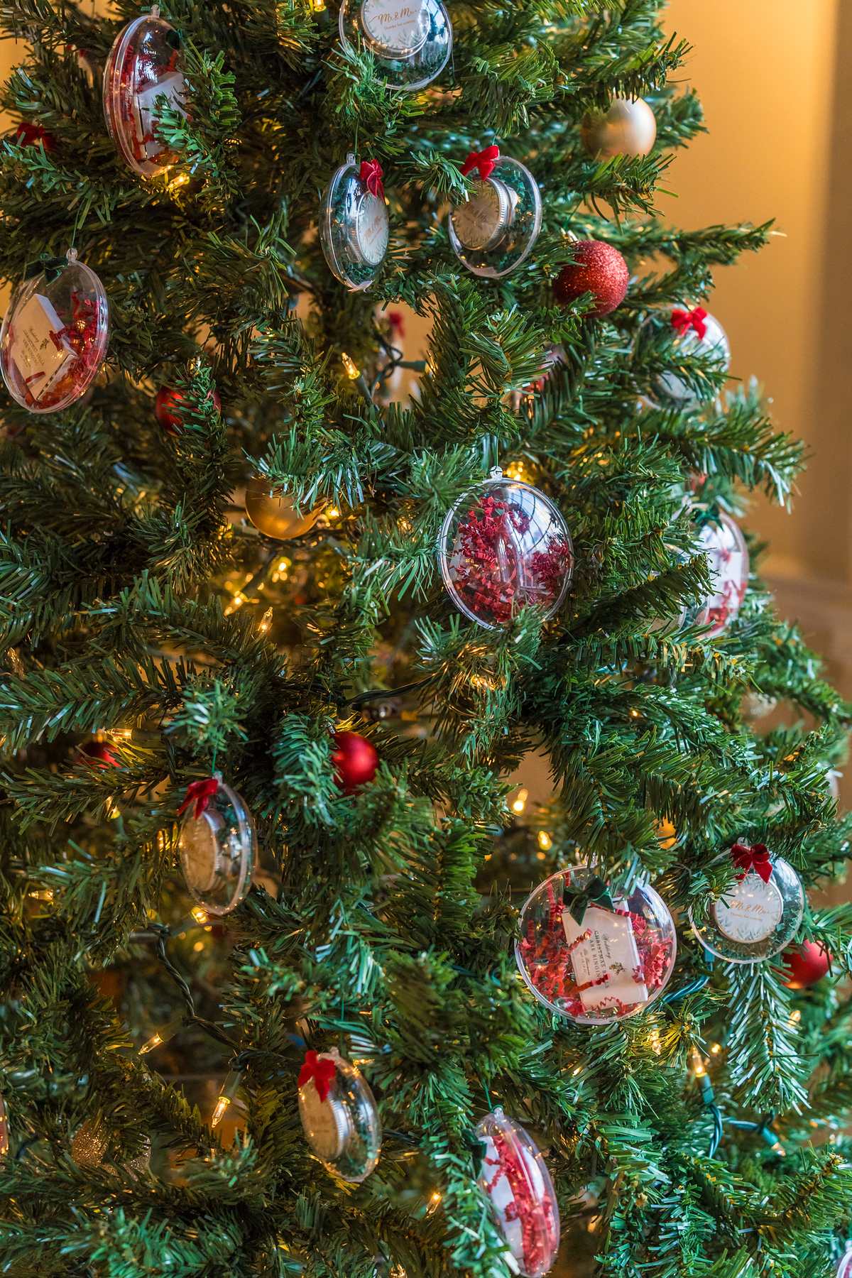 Christmas tree with red ornaments at a December wedding reception