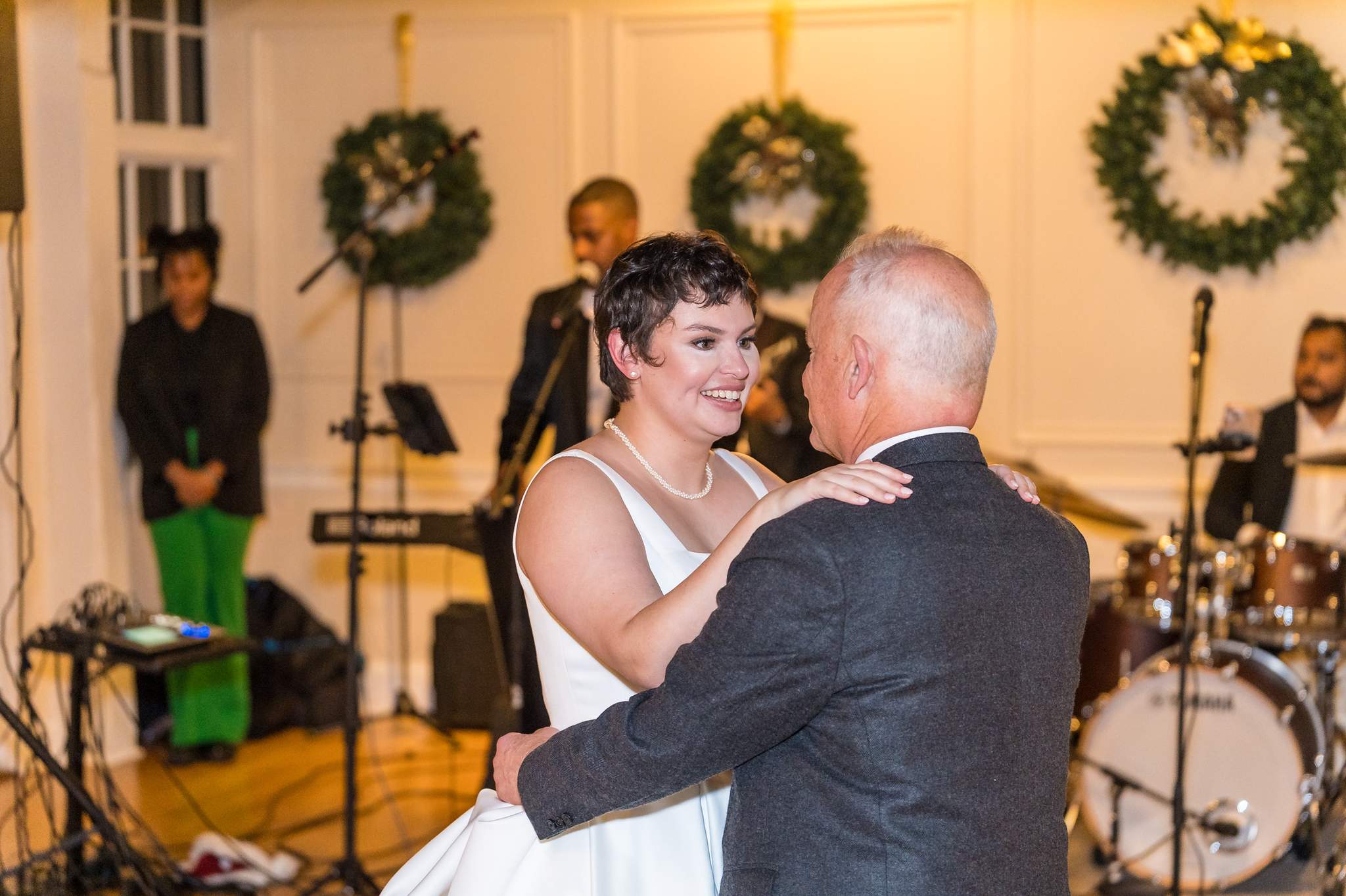Bride dancing with a family member at a Christmas wedding reception