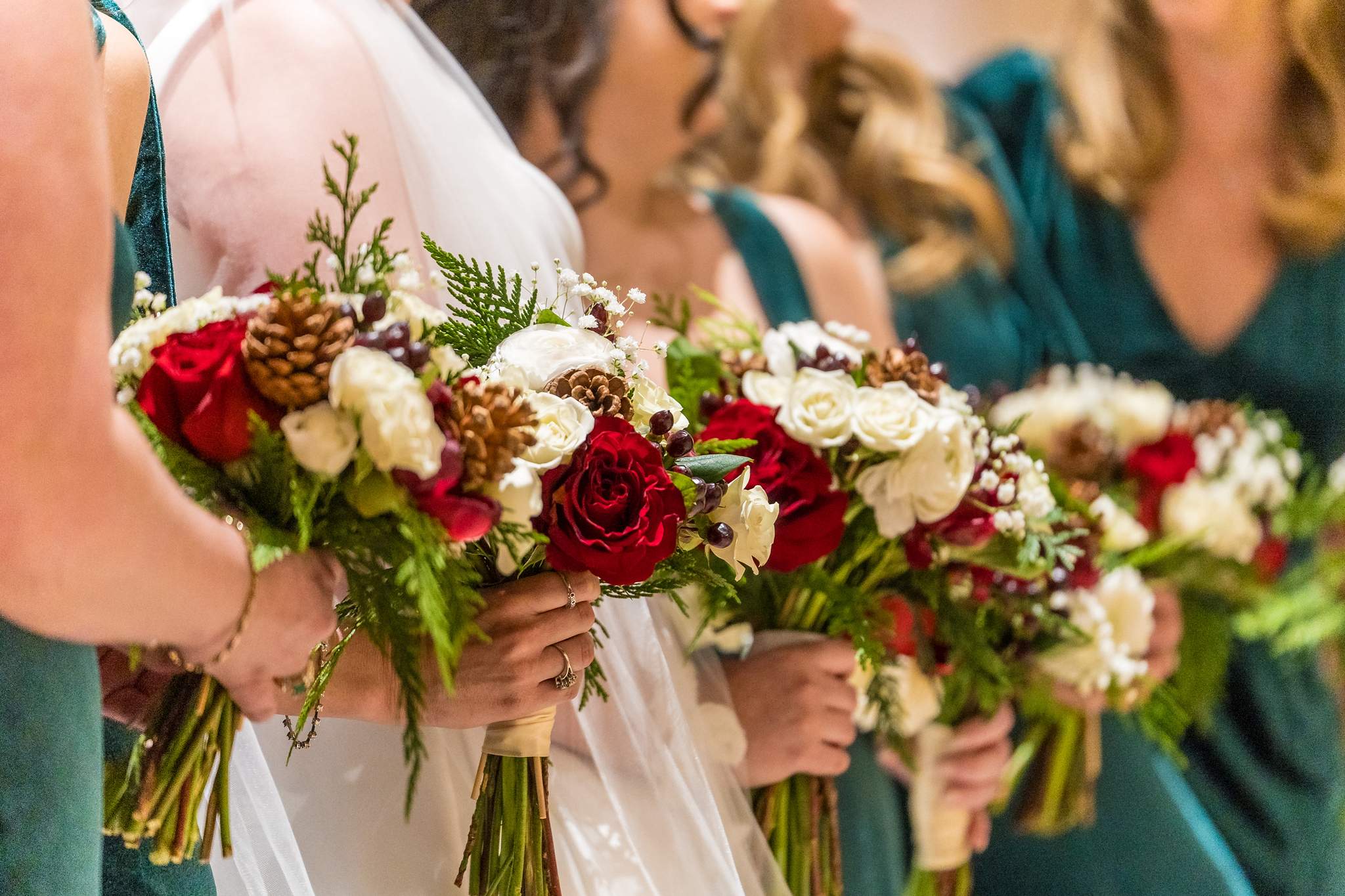 Close up of red rose and white flower bouquets for a Christmas wedding