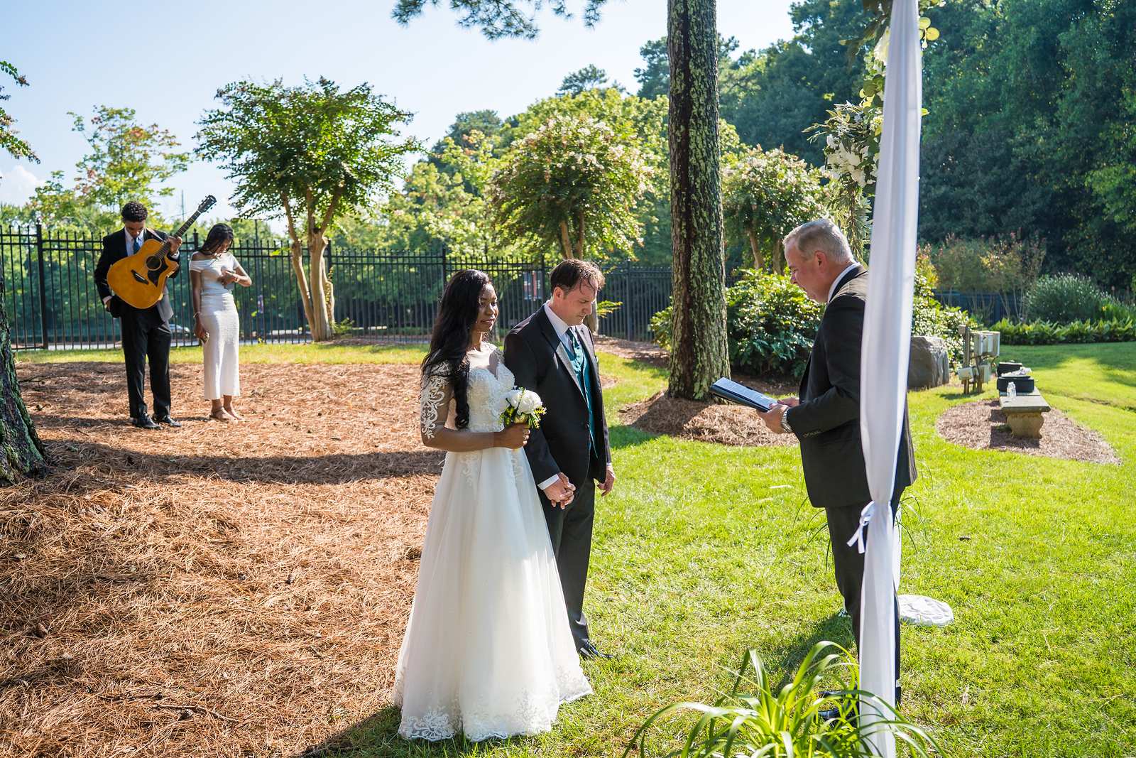 Elopement ceremony on a lawn with a guitarist playing in Atlanta