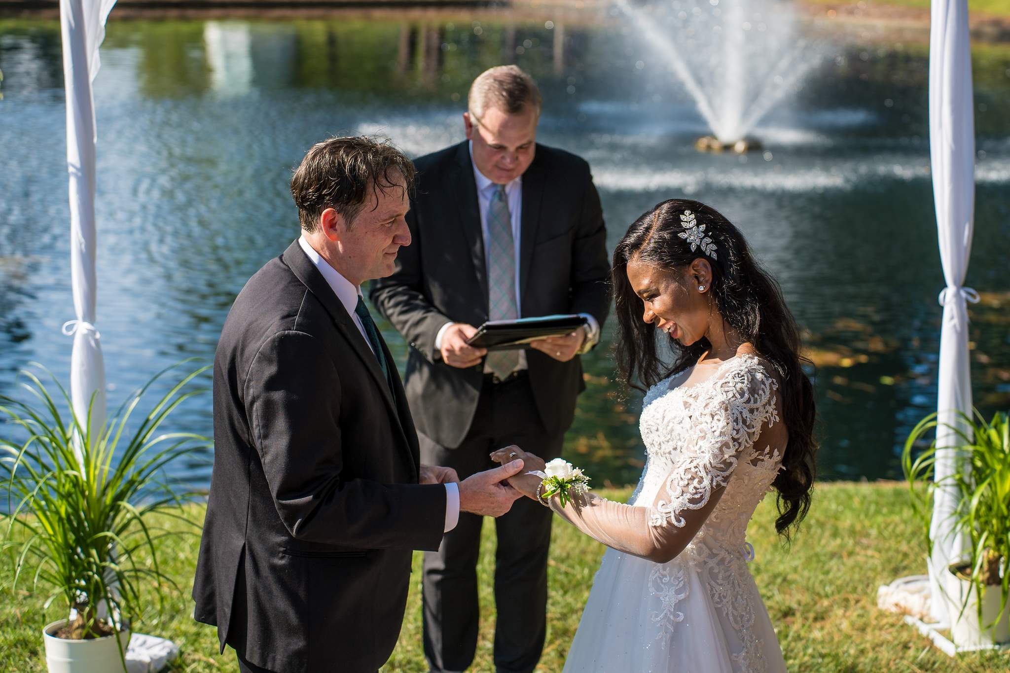 Ring exchange beside a pond fountain at an Atlanta elopement
