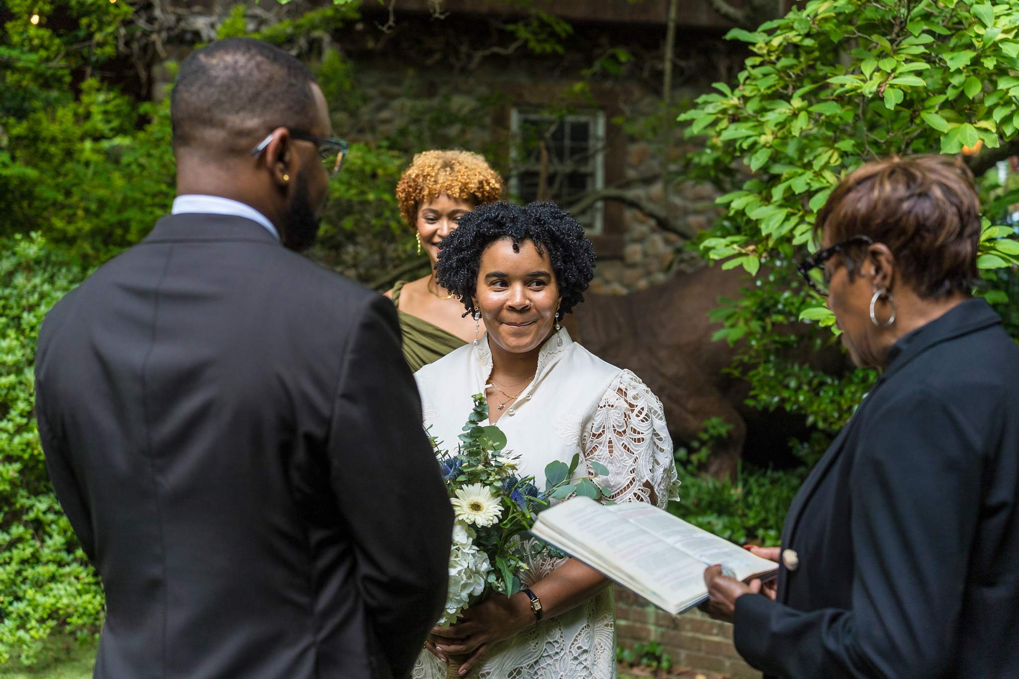 Officiant reading vows during a backyard garden elopement in Atlanta