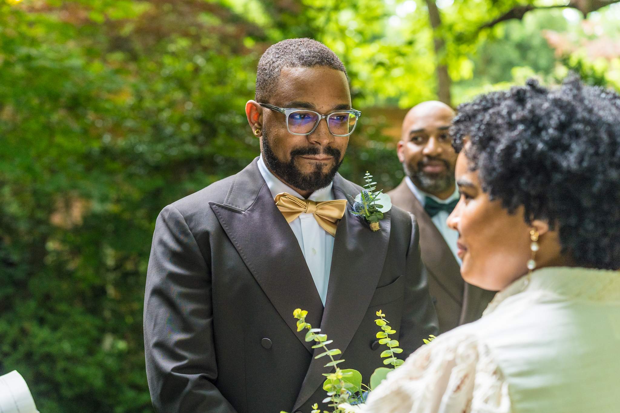 Groom smiling at the bride during their garden elopement ceremony