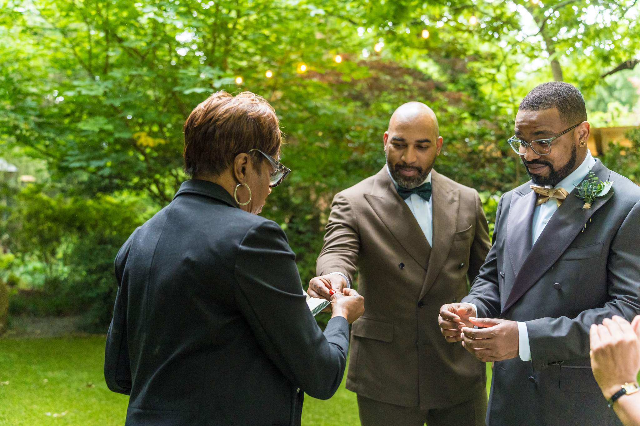 Officiant blessing the rings at a garden elopement