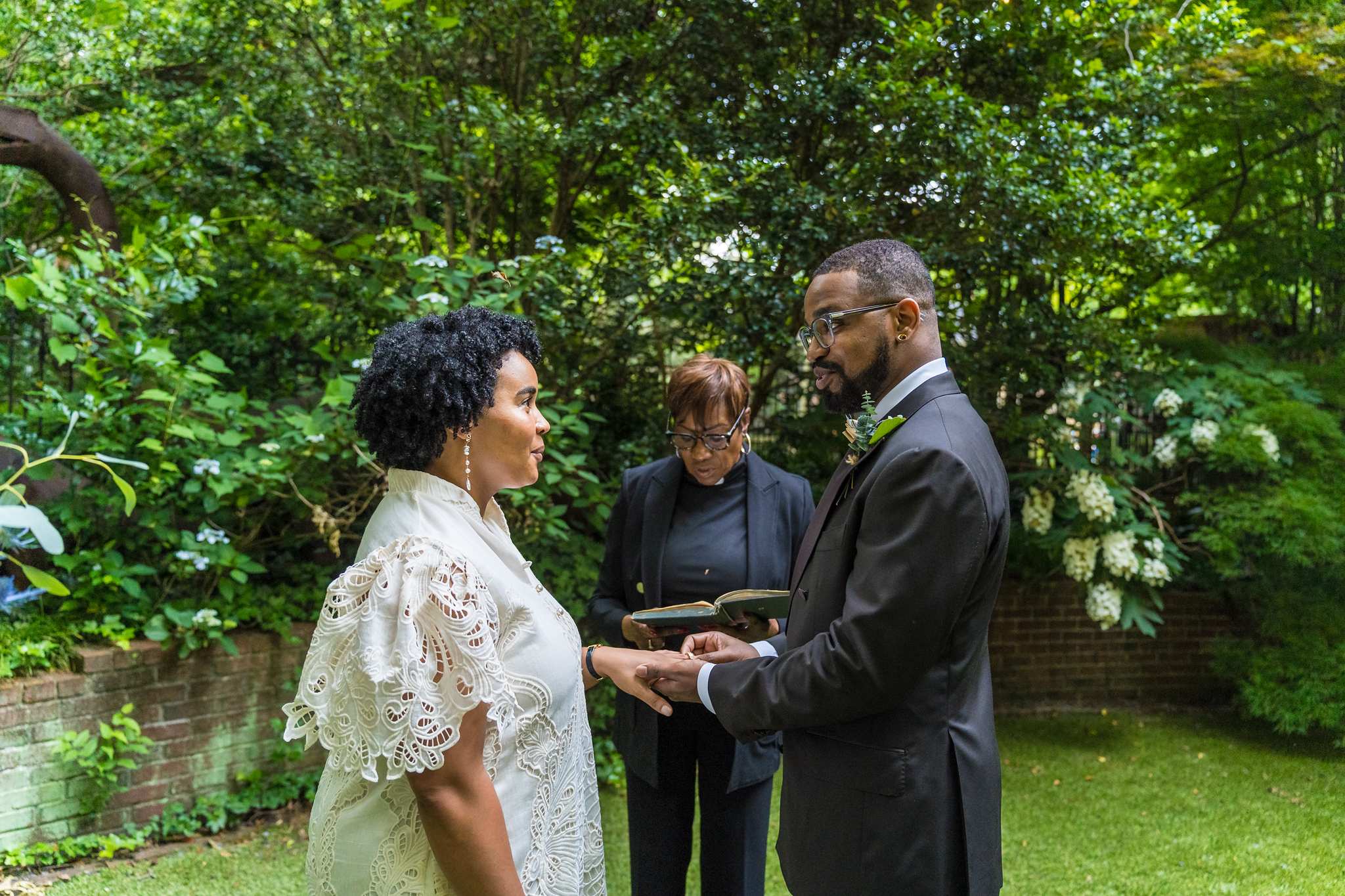 Couple holding hands during the ring exchange at an Atlanta elopement
