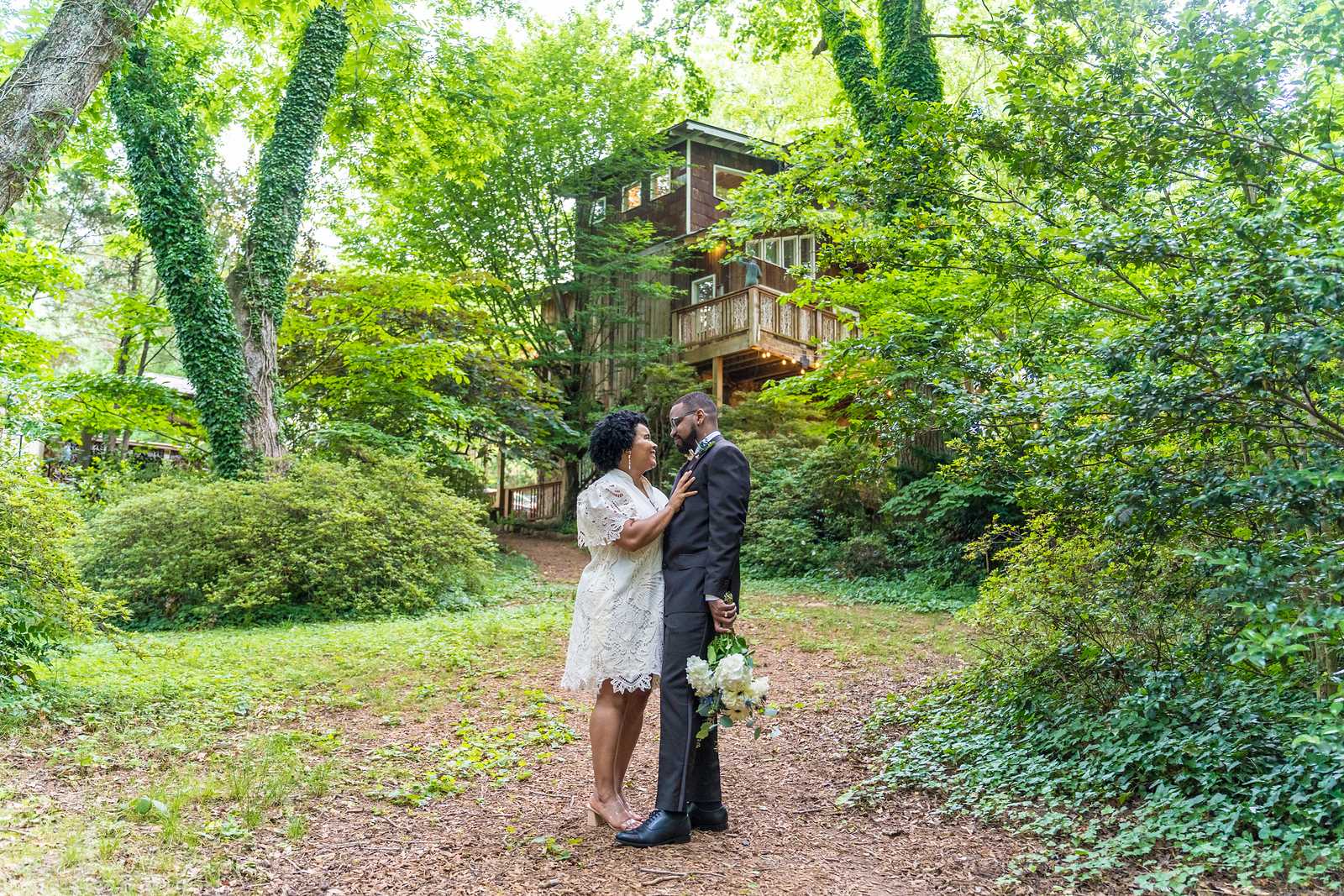 Newlyweds standing together on a garden path after their Atlanta elopement