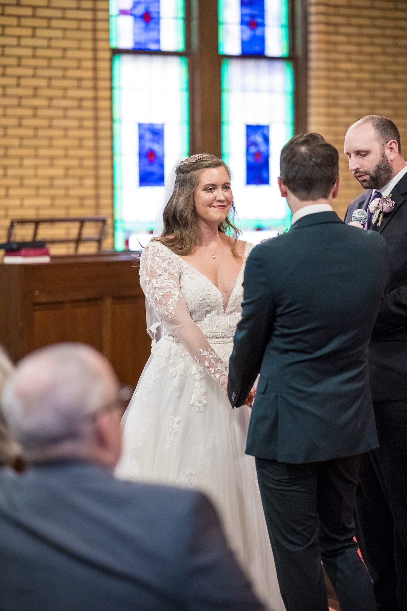 Bride and groom facing each other during their ceremony at Fayetteville First United Methodist Church