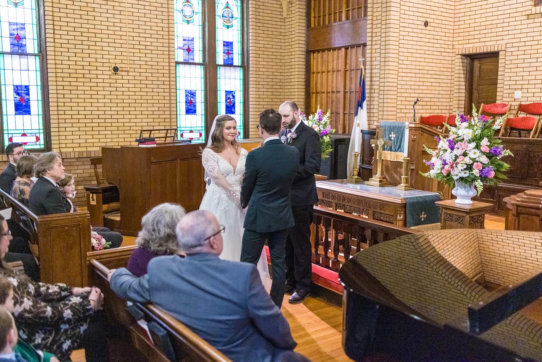 Wedding ceremony at the front of the sanctuary at Fayetteville First United Methodist Church