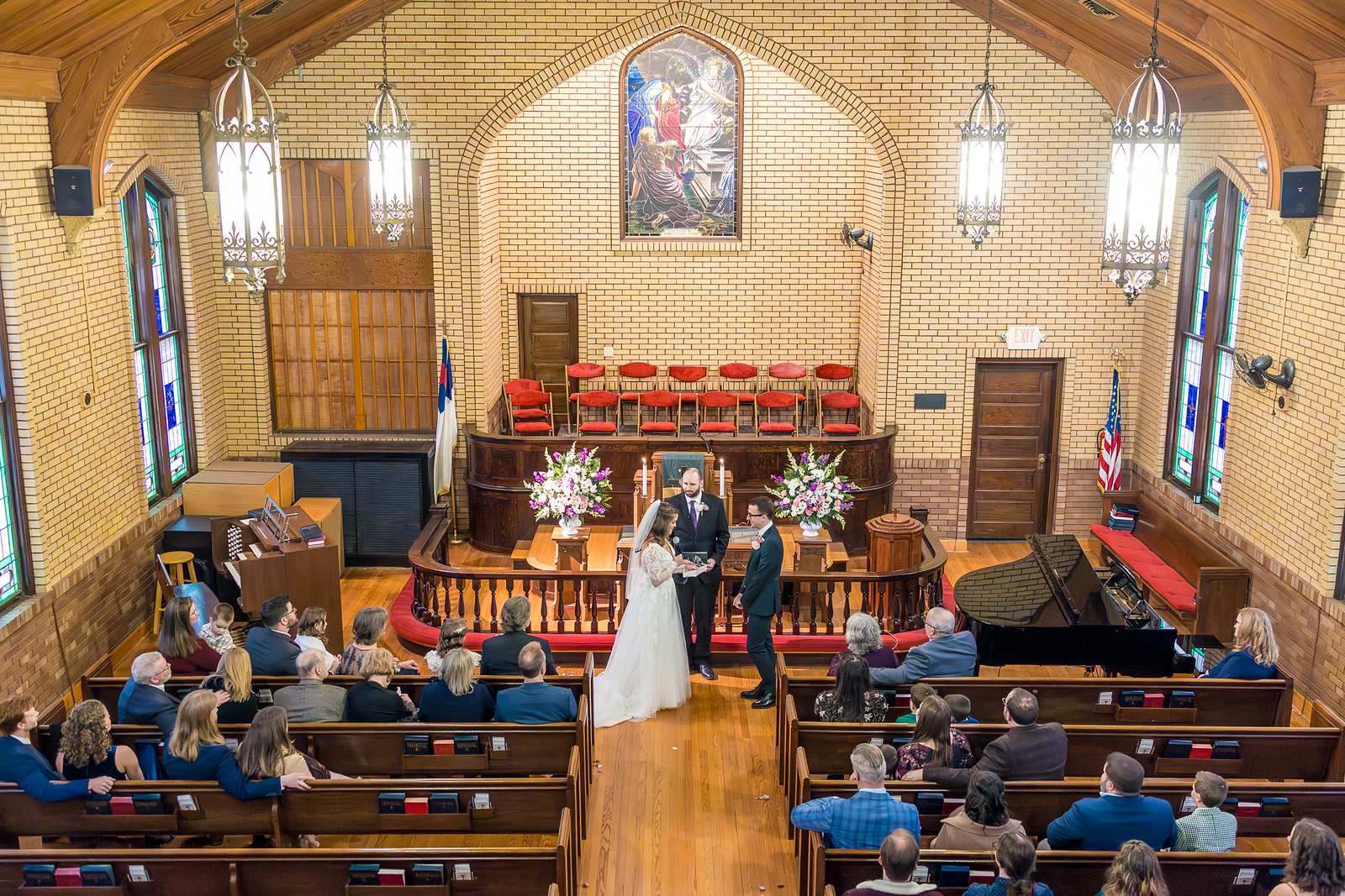 Wide view of a wedding ceremony from the back of Fayetteville First United Methodist Church
